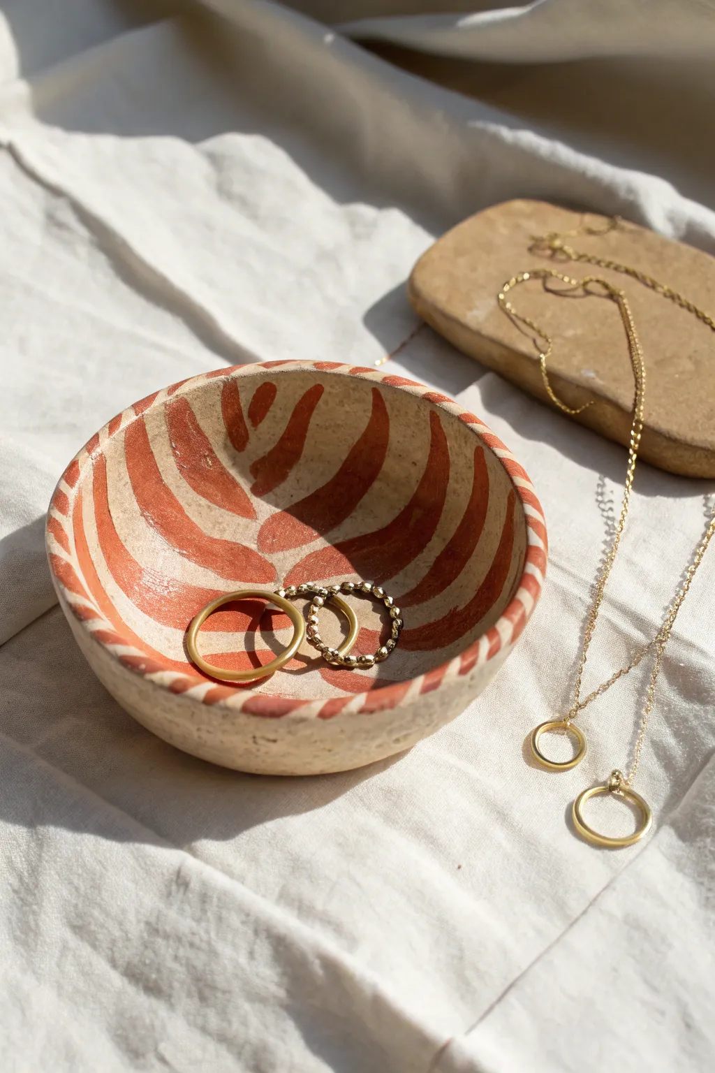 Wavy rim air-dry clay jewelry bowl with bold stripes, minimalist boho styling, perfect for beginners.