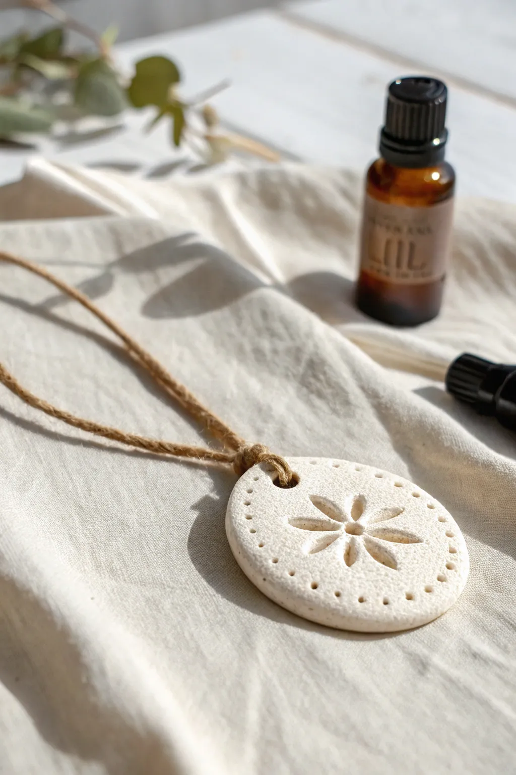 Minimal air dry clay diffuser pendant with porous texture, ready to scent your day naturally.