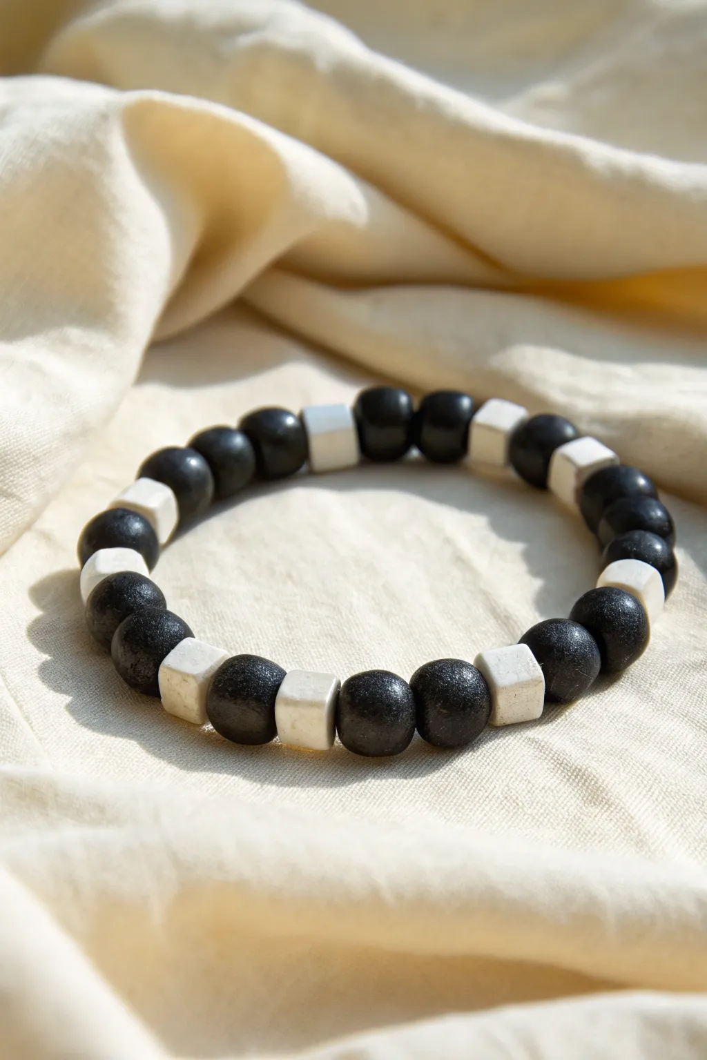Crisp black and white checkerboard sections make this clay bead bracelet feel modern and handmade
