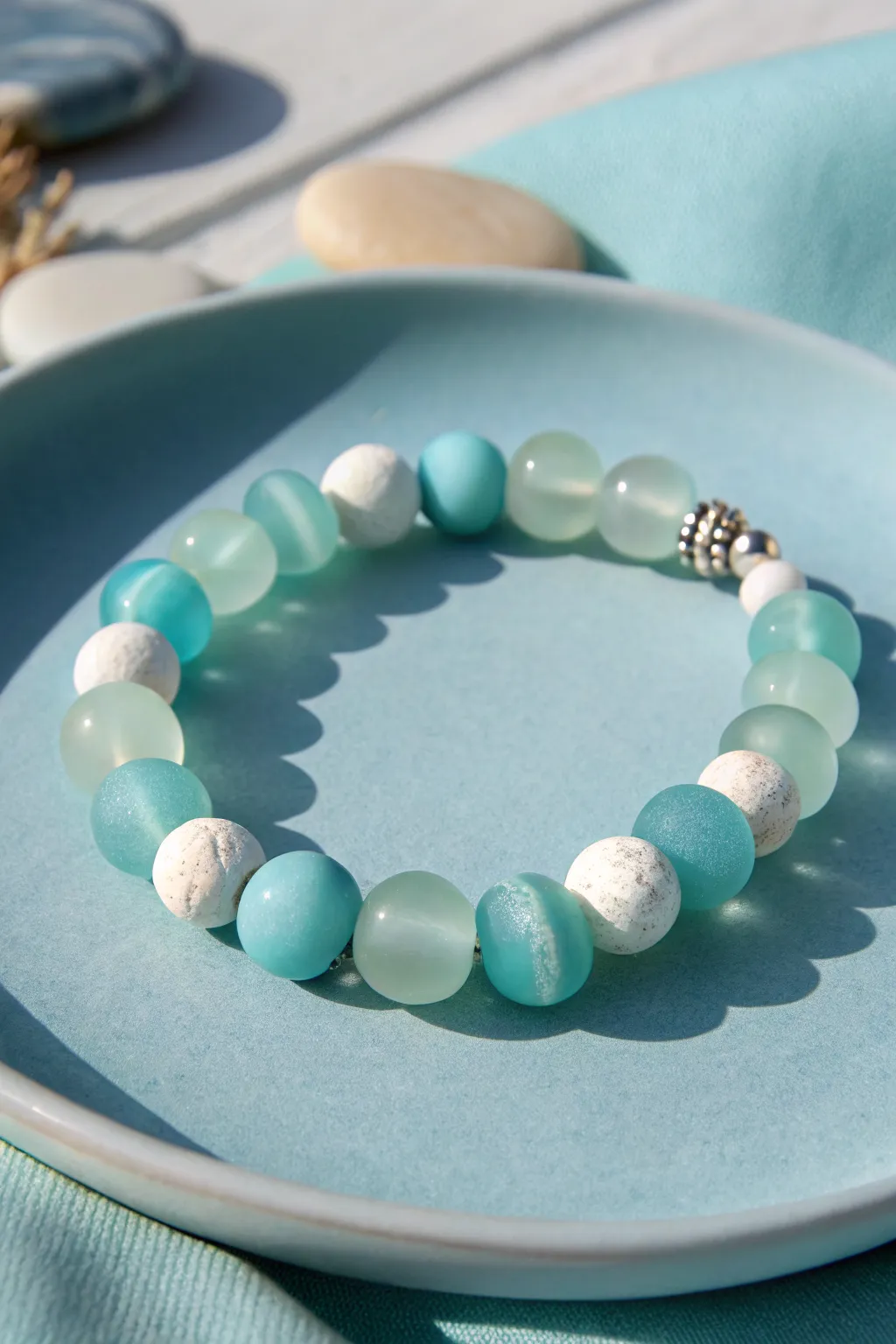 Sea glass hues and crisp white clay discs make this minimalist summer bracelet glow.