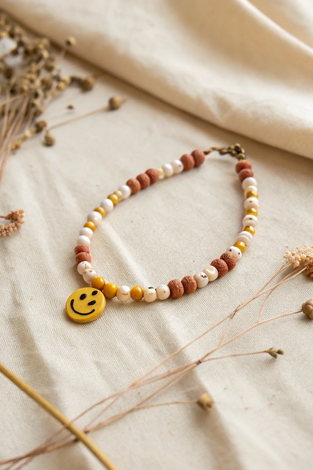 Checkerboard color rhythm meets a cute centered smiley bead for an easy, modern clay bracelet.