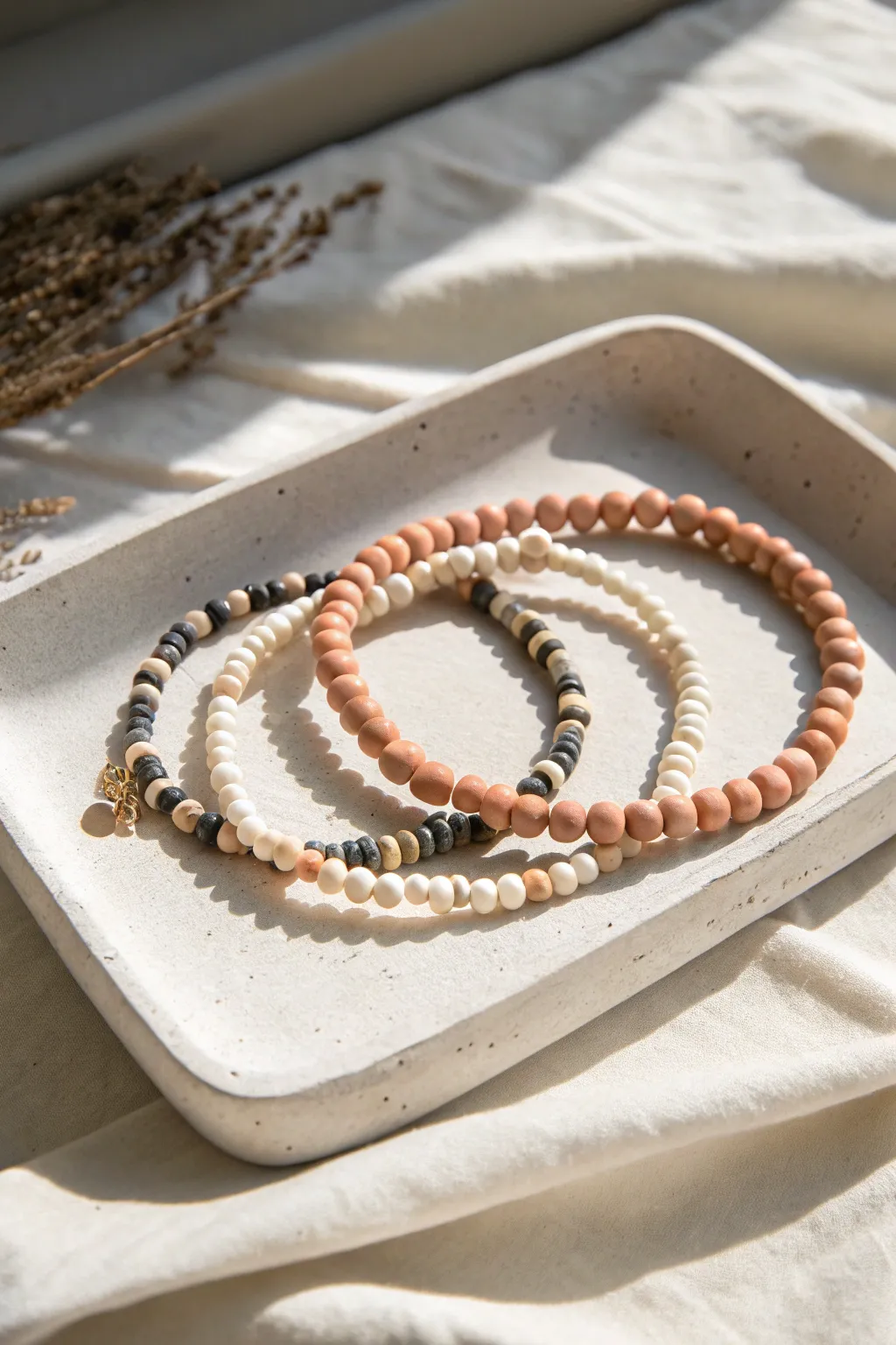 Three coordinated clay bead bracelets with heishi discs and round accents for a texture-rich bestseller.