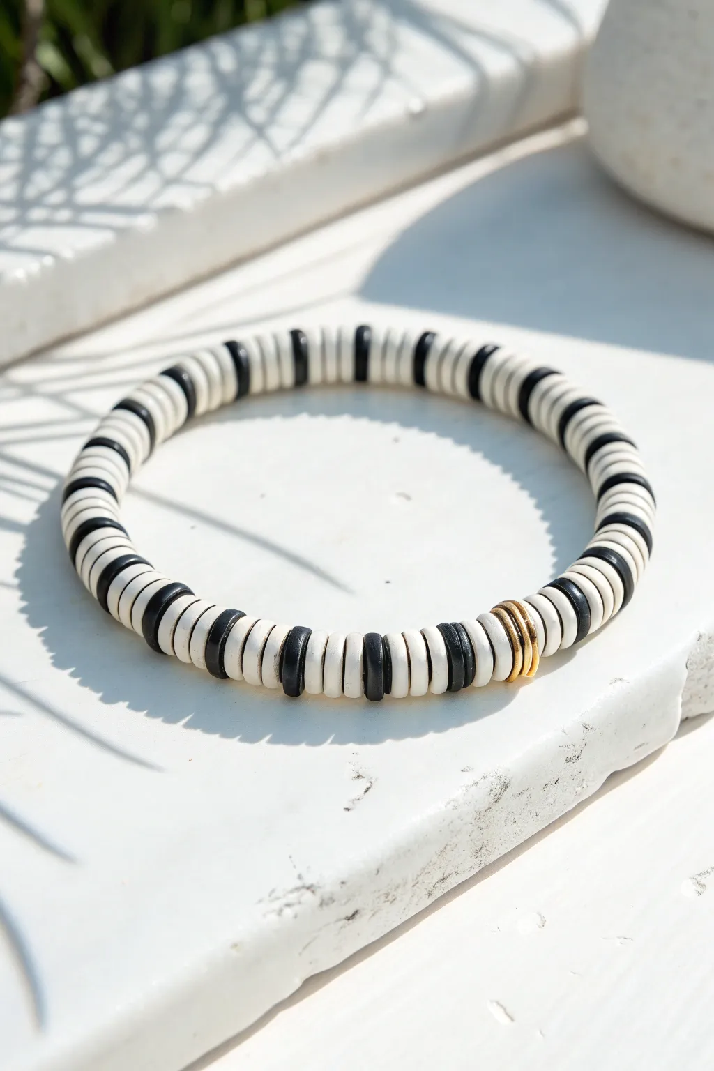 Bold black-and-white heishi clay bead stripes for a crisp, modern bracelet with boho charm.