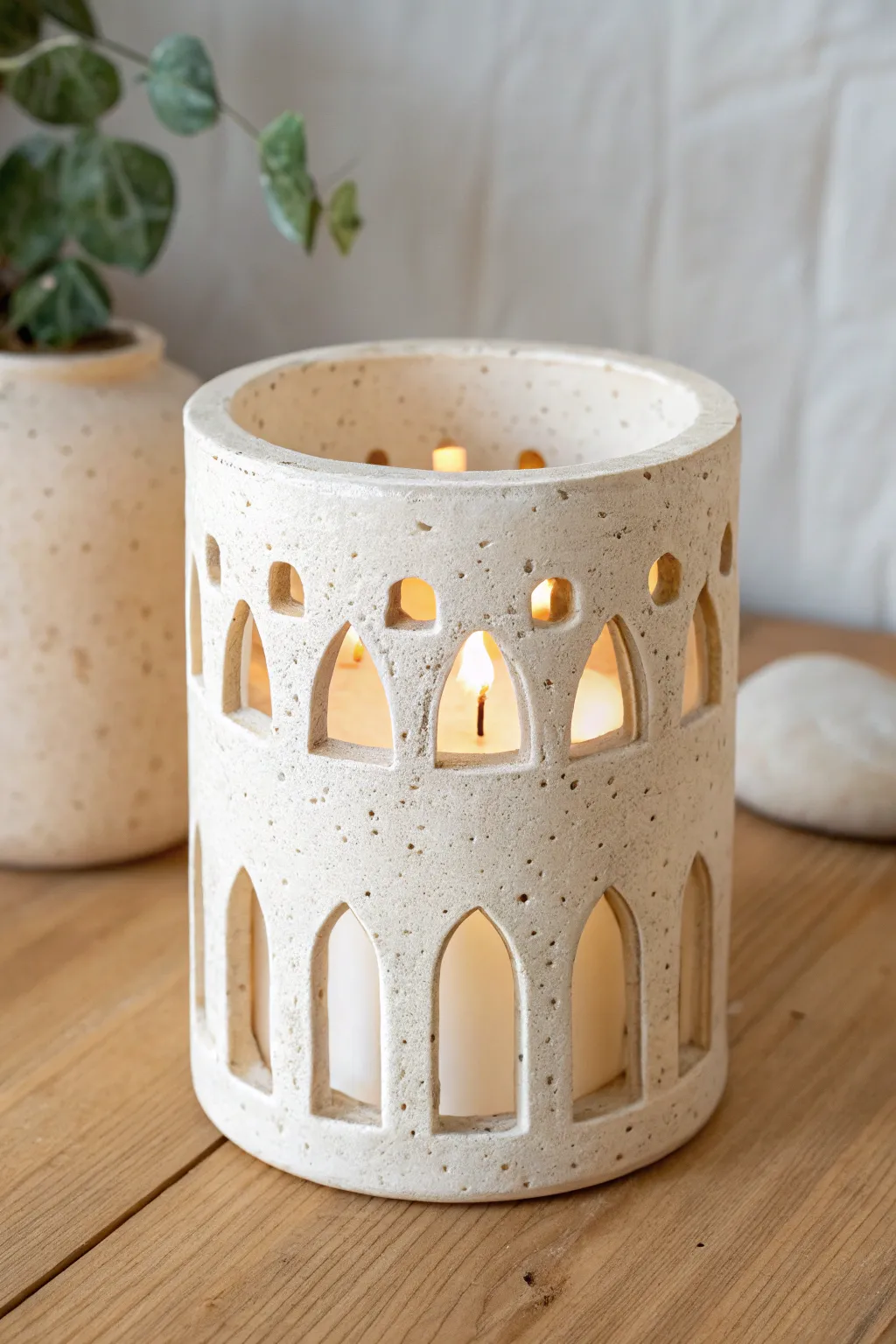 Minimal carved windows turn a simple tealight holder into a cozy, architectural clay cutout idea.