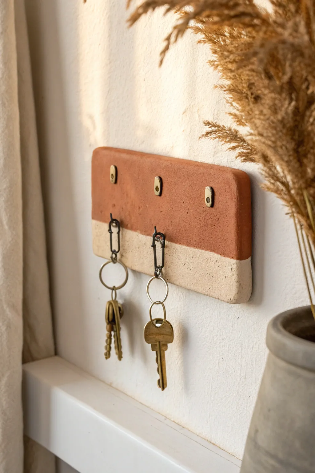 Minimal clay backplate key hook in warm earth tones, a practical handmade gift for him.