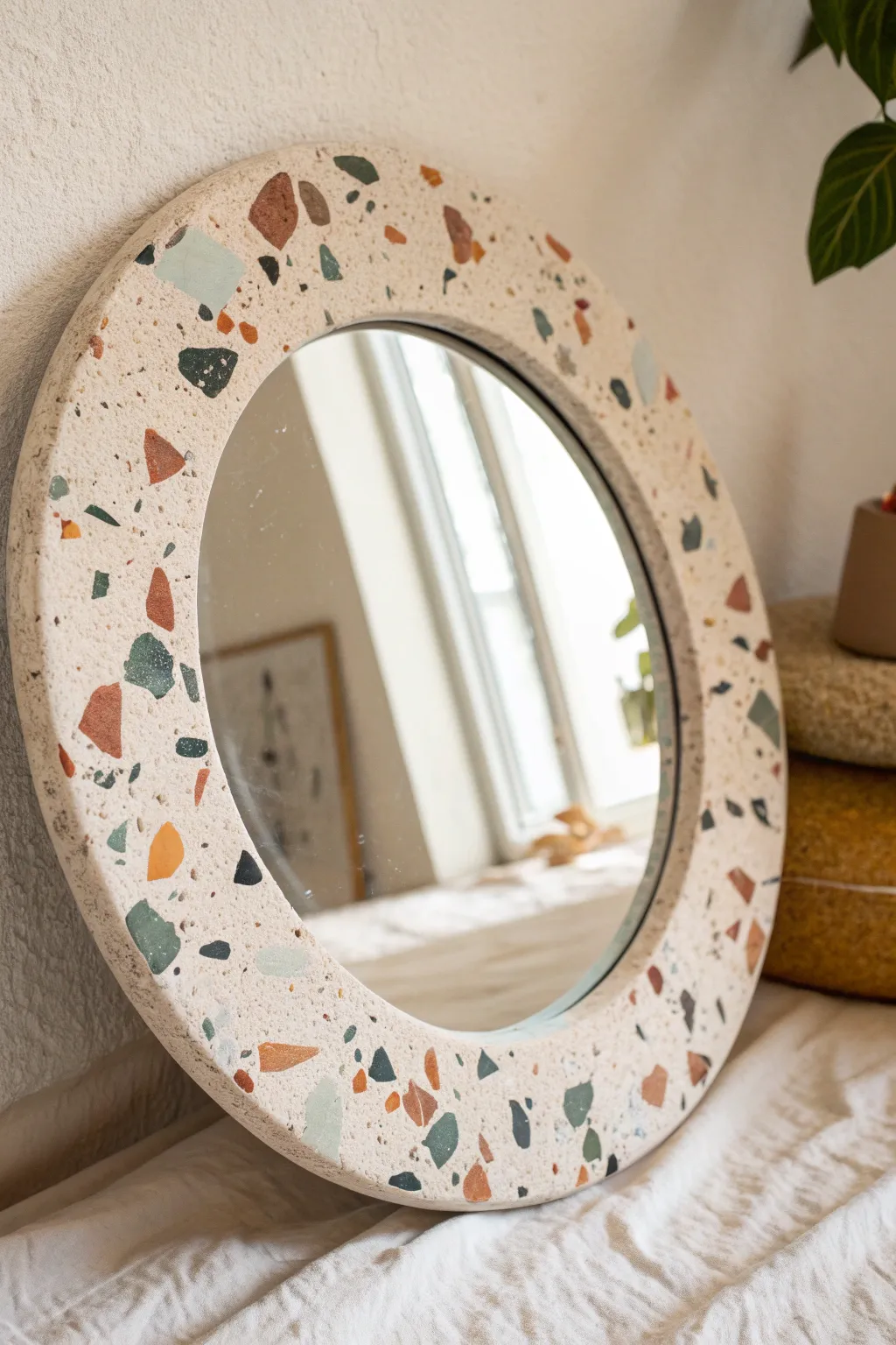 Terrazzo-speckled clay mirror frame with confetti bits for an easy, modern boho accent.