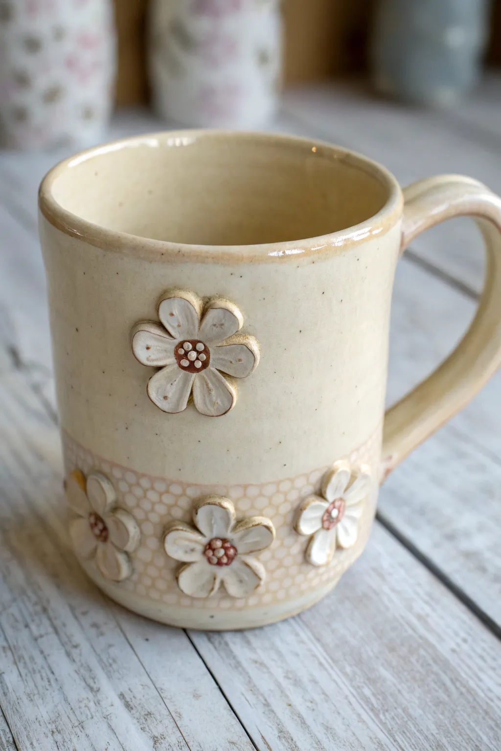 Minimal clay mug with sweet 3D floral appliqués and softly pooling glaze, Scandi-boho charm.