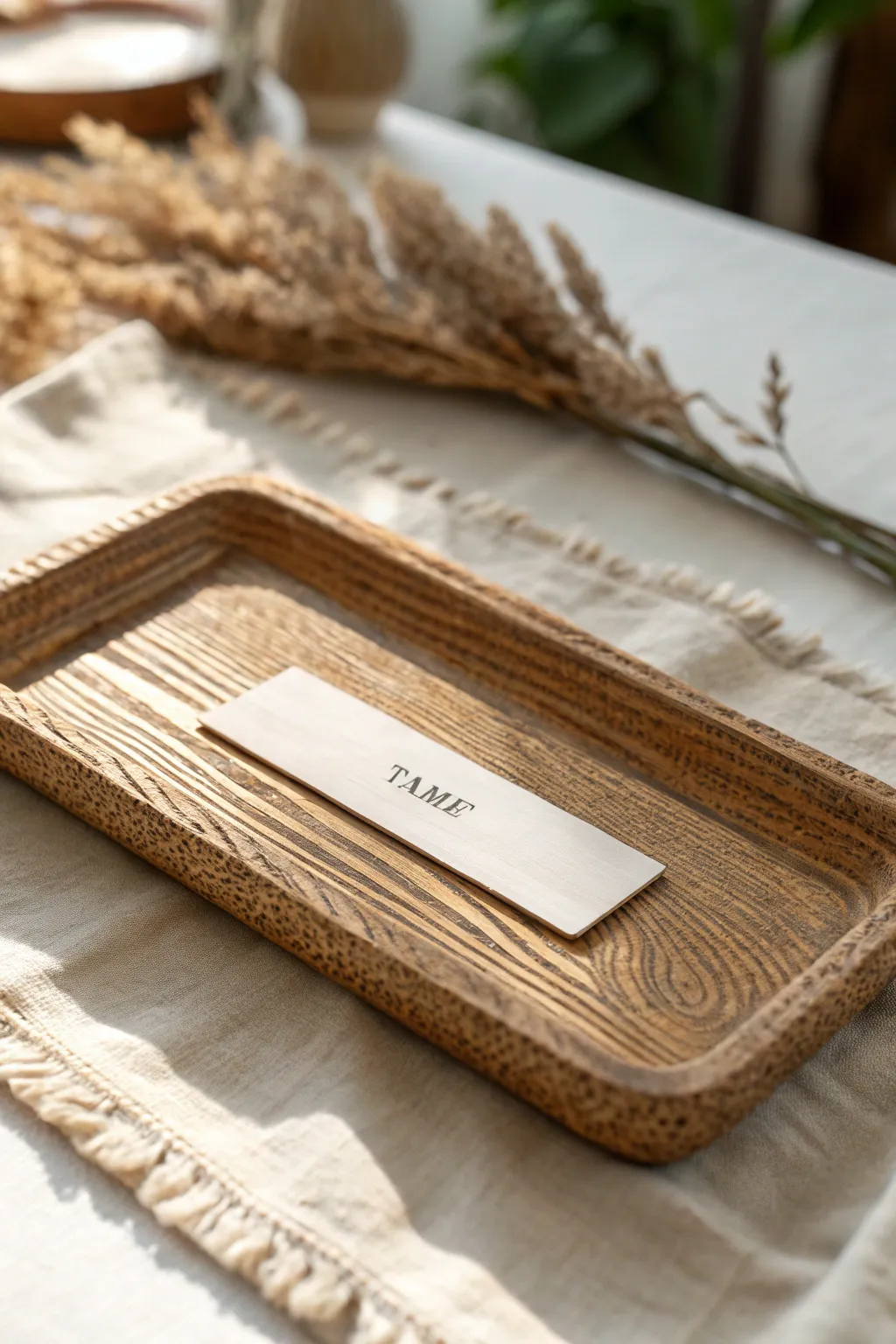 Rustic wood-grain clay name plate with warm wash detail, minimalist Scandinavian boho vibe