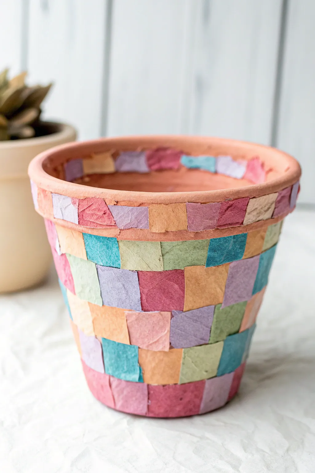 Vibrant tissue paper collage clay pot, kid-friendly and charmingly imperfect for easy painting fun.