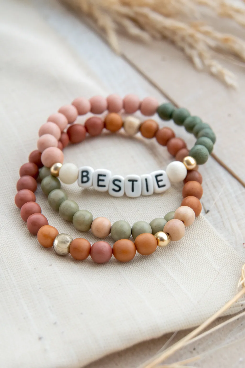 Half-and-half bestie clay bead bracelets with mirrored colors and shared letter beads, giftable set.