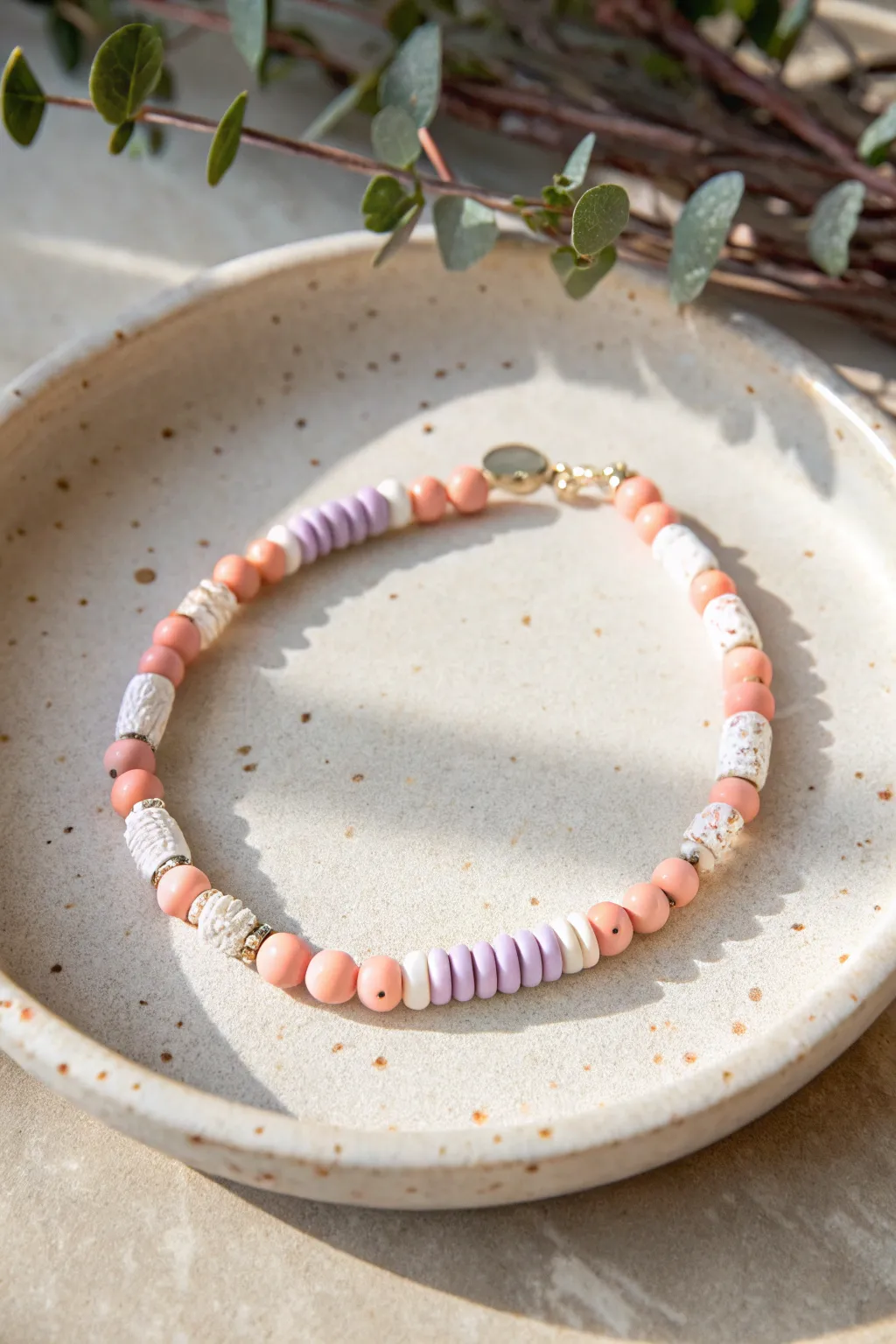 Pink confetti heishi bracelet with white, coral, and lavender sprinkles for a sweet look