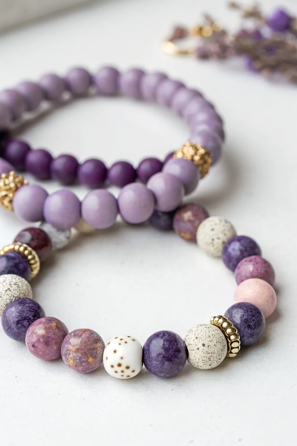 Purple sprinkle-mix clay bead bracelet with soft white pops and tiny gold spacers, minimal and sweet