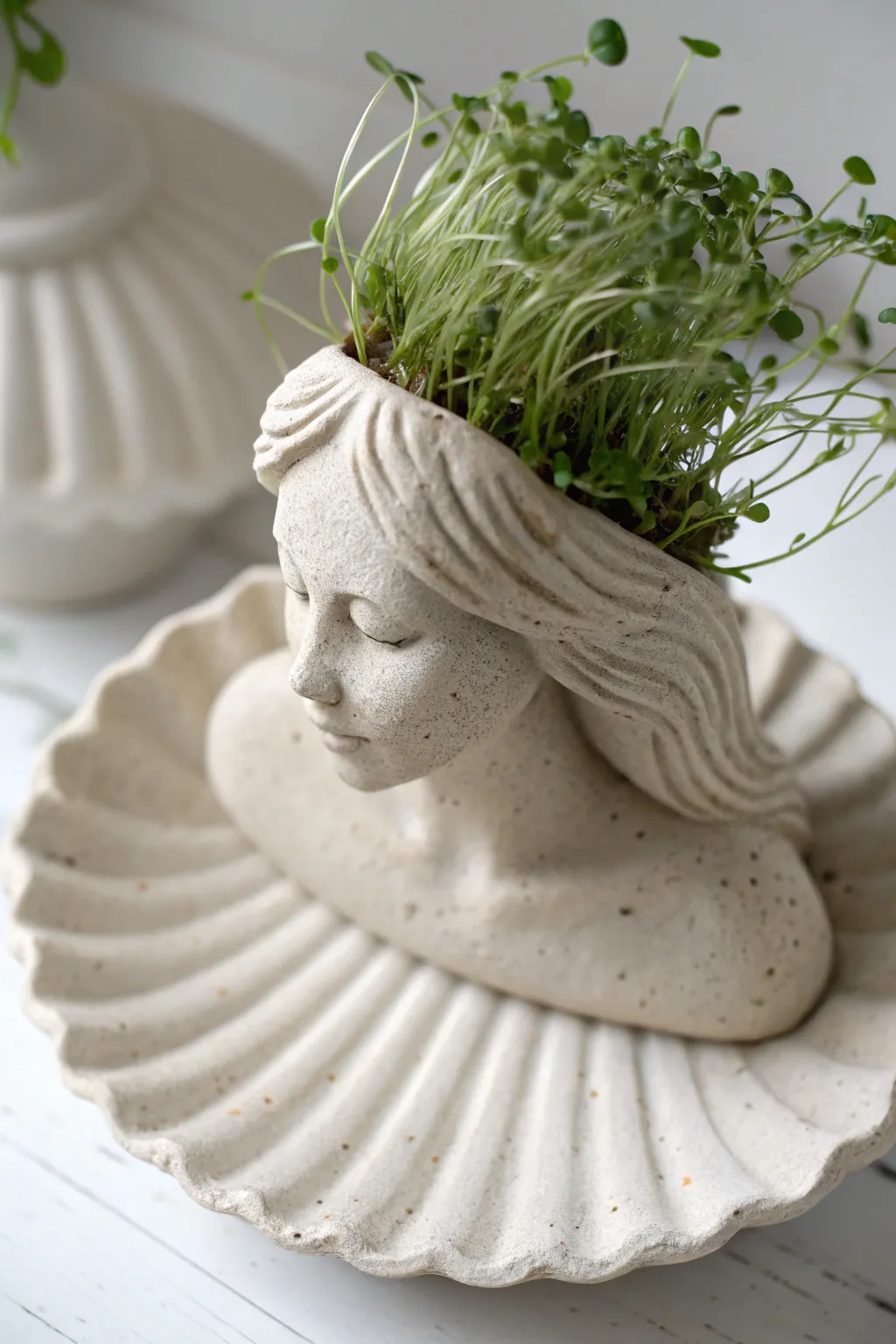 Mermaid shell chia pet with lush green sprouts, minimalist clay decor for a dreamy boho vibe.