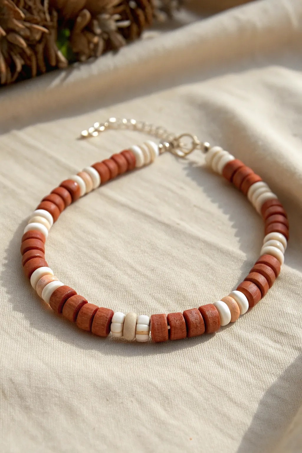 Simple checkerboard clay disc bead bracelet in terracotta and ivory, minimalist and chic.