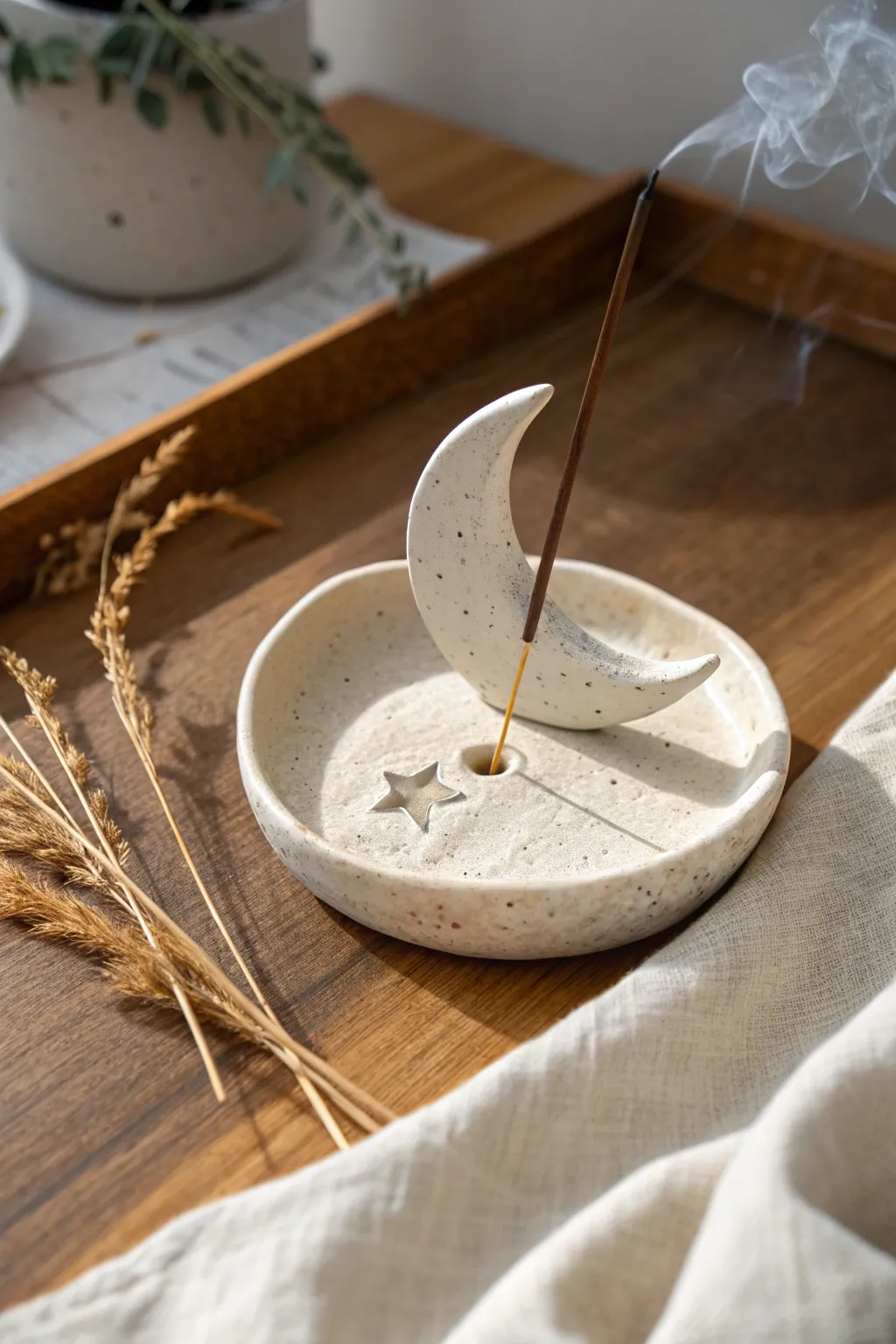 Minimal moon and star incense rest in matte clay, cozy neutrals, soft smoke, and calm boho styling