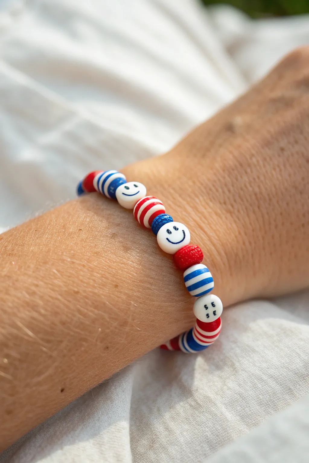 Patriotic smiley bead bracelet in red, white, and blue for effortless Fourth of July style.