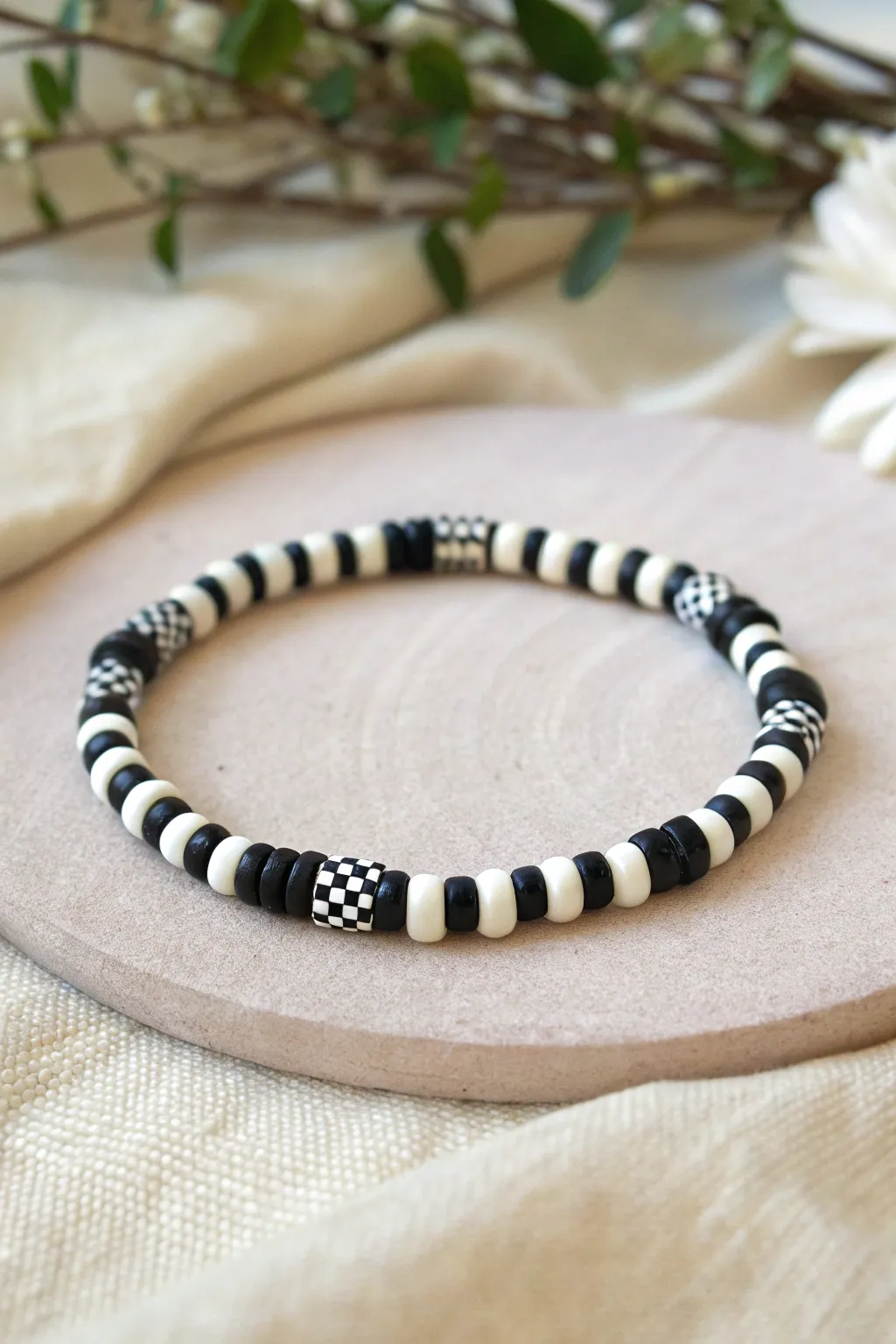 Bold black and white checkerboard blocks make this heishi clay bead bracelet feel modern and boho