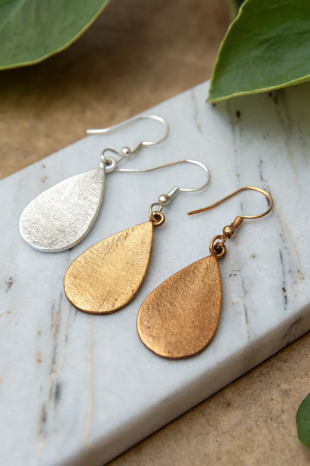 Two-tone metal clay drop earrings with sleek Scandinavian lines and warm boho contrast.