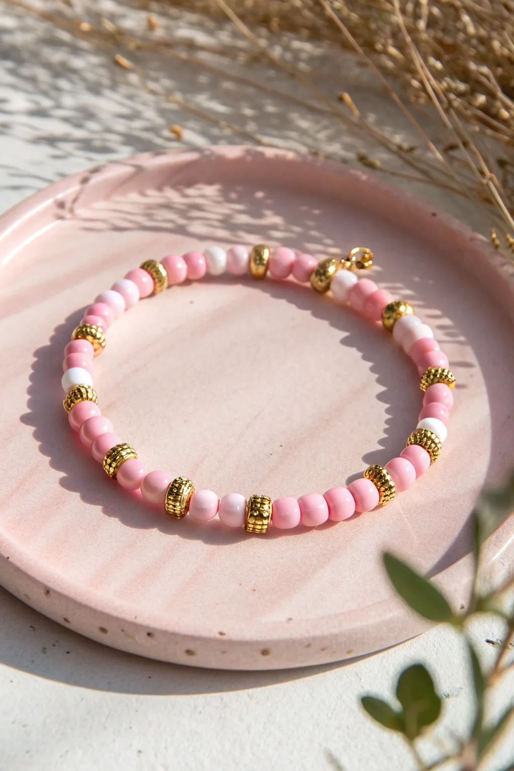 Pink checker clay bead bracelet with micro spacers, styled minimal on a soft blush backdrop