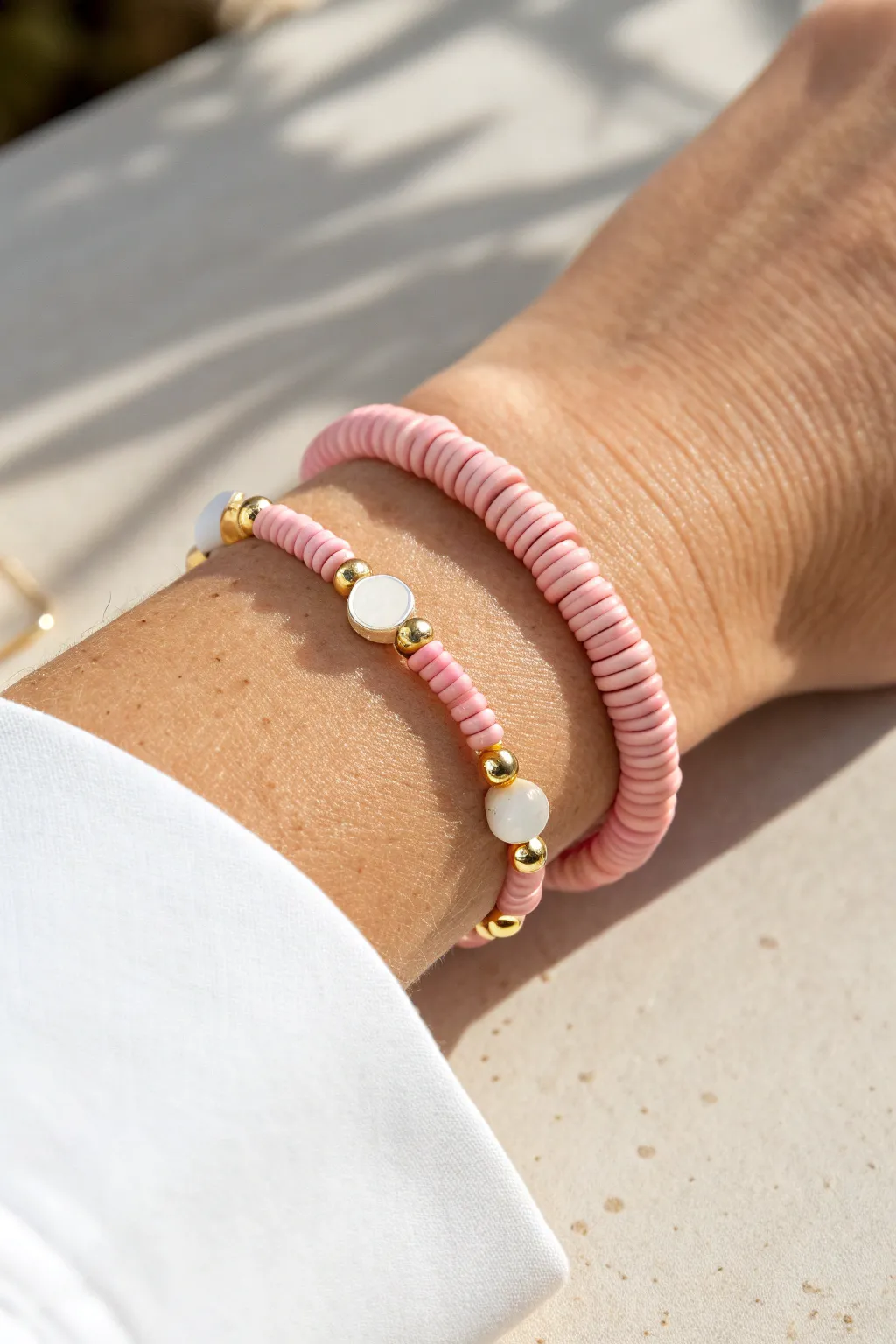 Pink preppy pinstripe clay bracelet with white heishi lines and tiny gold spacers