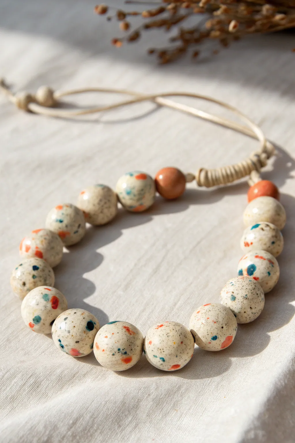 Terrazzo-speckled polymer clay bead bracelet in soft neutrals with muted color flecks.