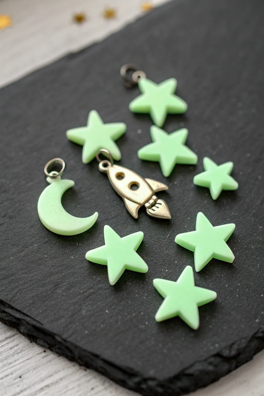 Glow-in-the-dark clay stars, moon, and tiny rocket charm for easy kid-friendly space crafts