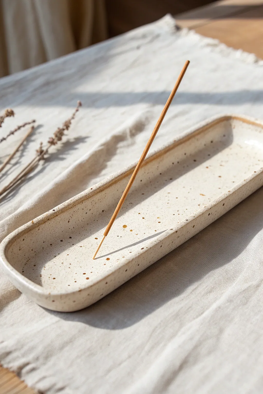 Minimal clay incense catch-all tray with carved lines, styled in soft Scandinavian boho light.