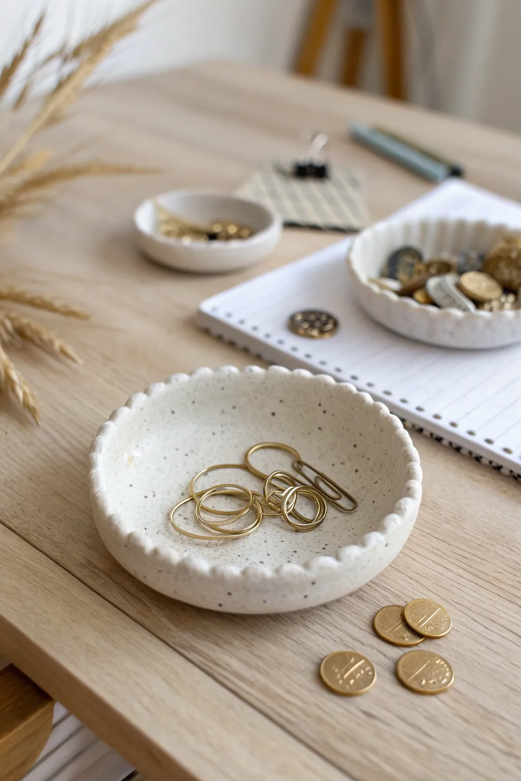Petite bead-edge clay dish keeps coins and clips tidy with minimalist Scandinavian charm.