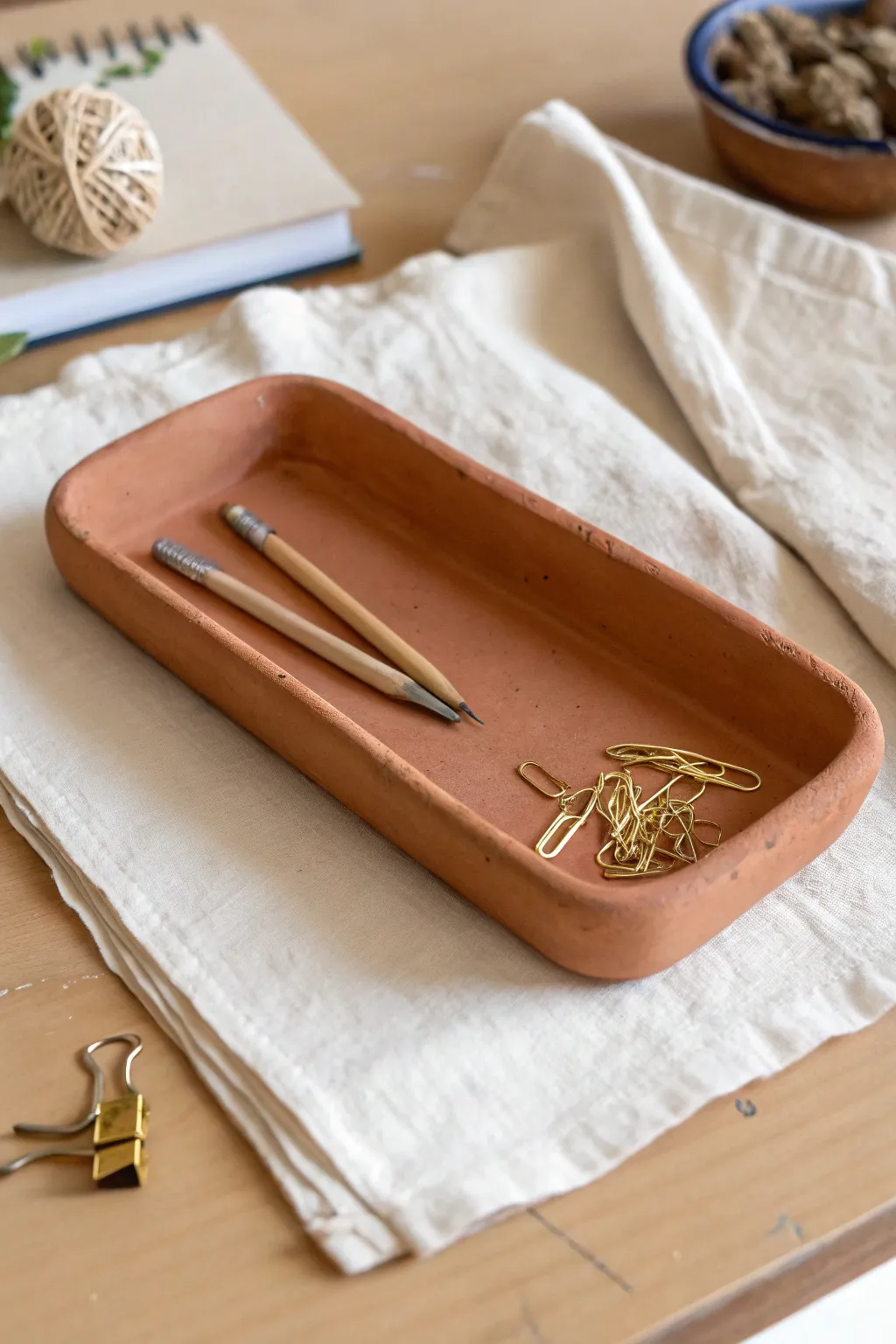 Minimal terracotta catchall tray to corral paper clips and tiny tools with warm, calm style