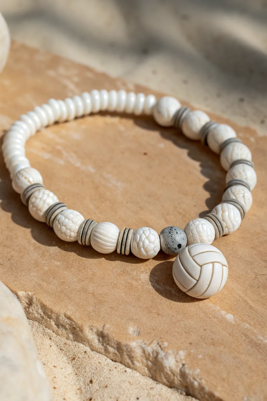 Marbled swirl clay discs and crisp white heishi beads create a modern volleyball bracelet centerpiece.