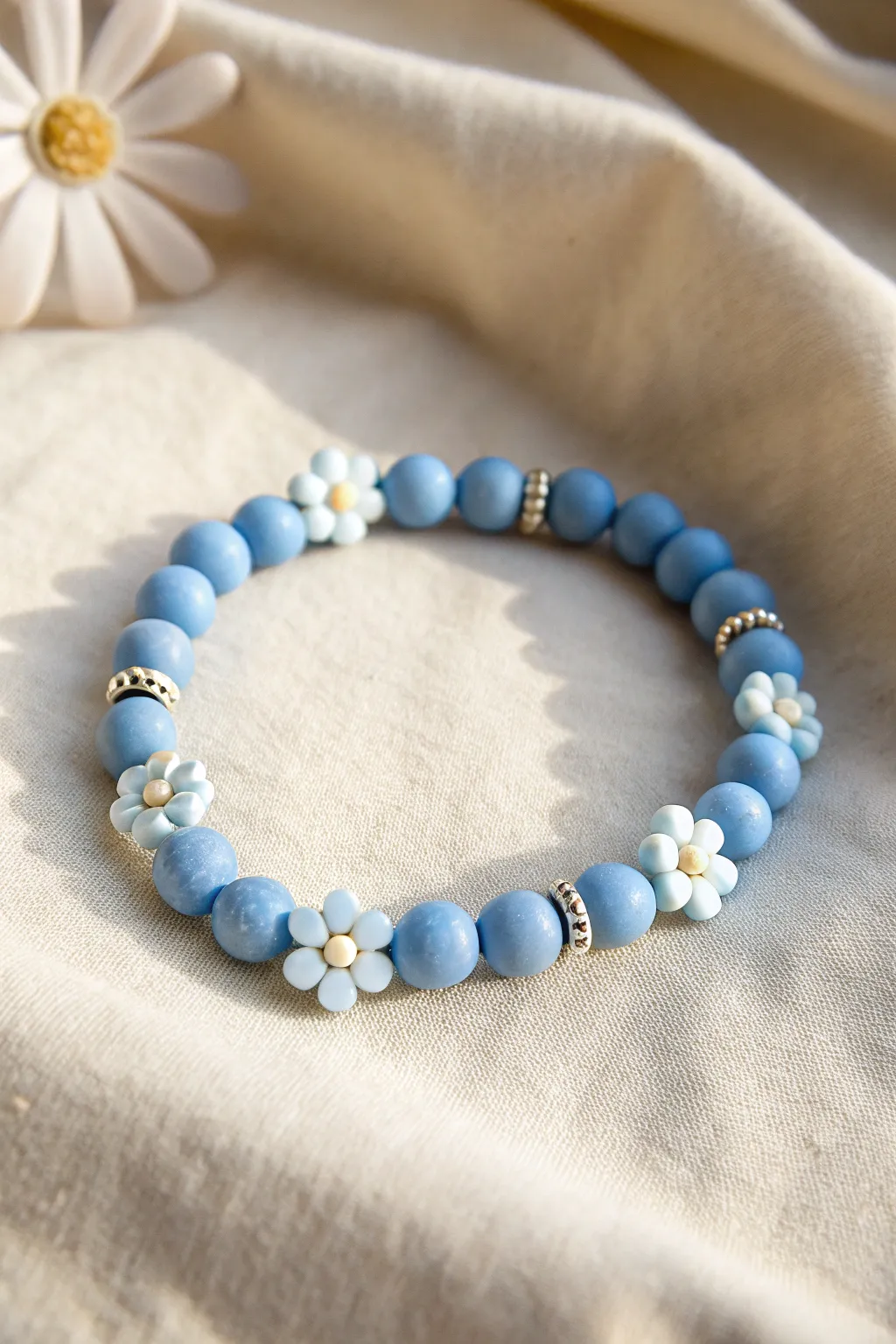Blue clay disc bead bracelet with tiny flower accents for a soft minimalist boho look