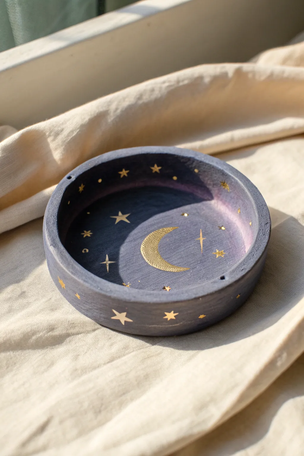 Crescent moon clay ashtray in dreamy night hues with tiny raised stars and subtle metallic glow