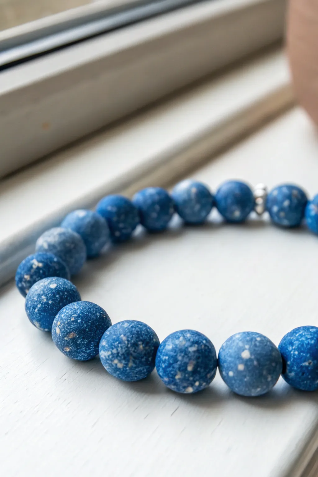 Blue speckled terrazzo clay beads with solid blue accents, a calm minimalist boho bracelet.