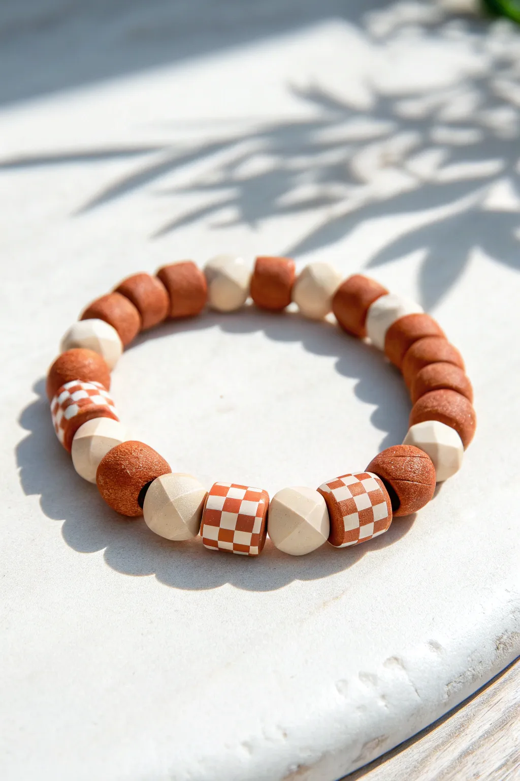 Two-color clay disc bead bracelet in a crisp checker pattern, minimal and softly boho
