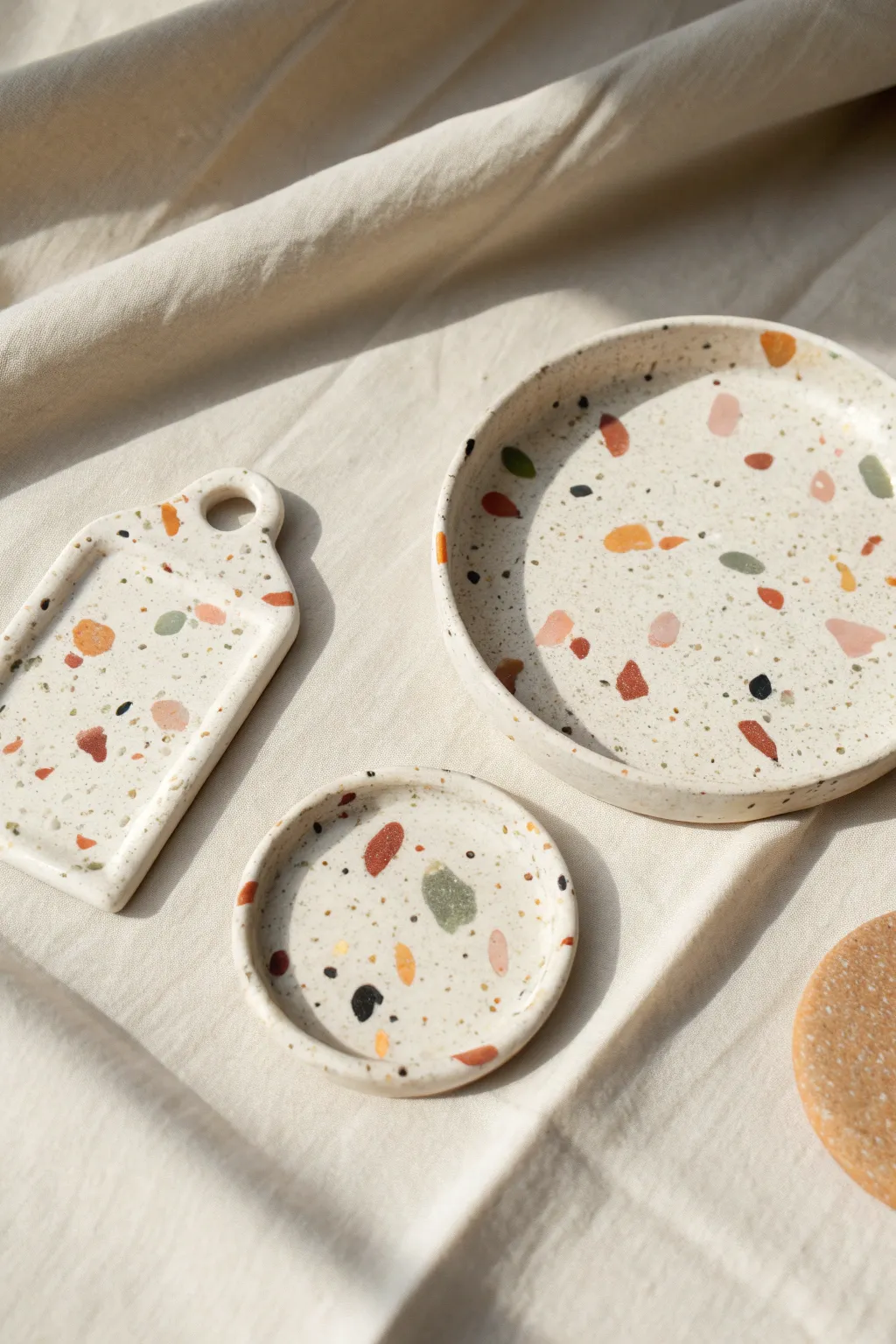 Terrazzo-style clay coaster, charm, and mini tray in soft speckles and clean Scandinavian style