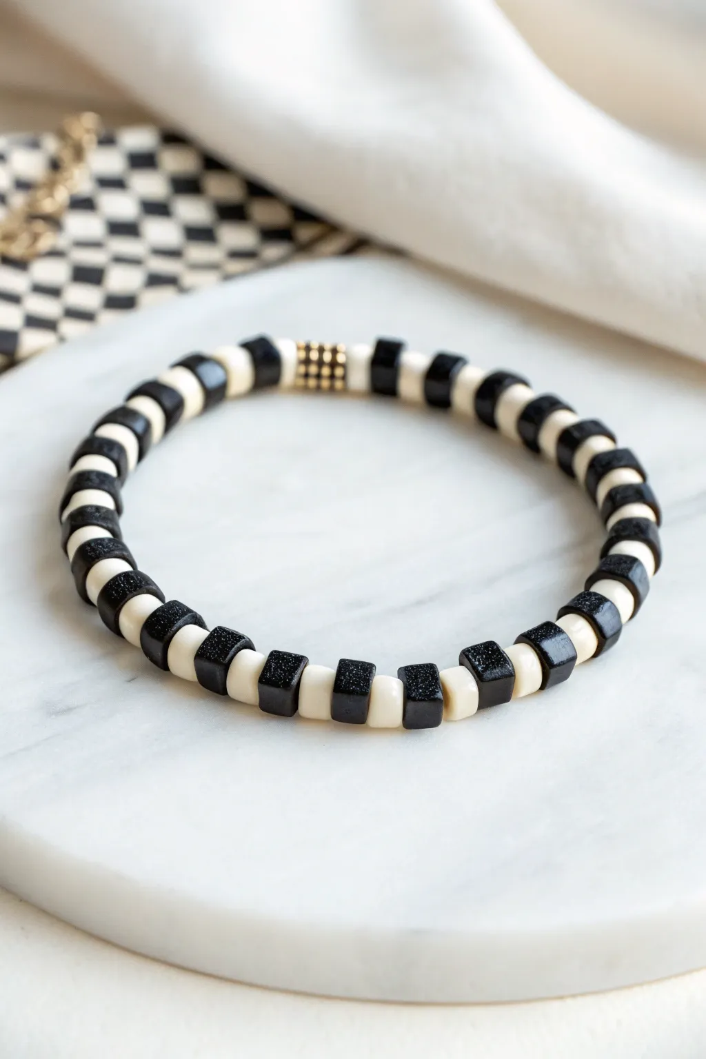 Mini checkerboard clay disc bracelet in bold black and white, minimalist, easy, and handmade.