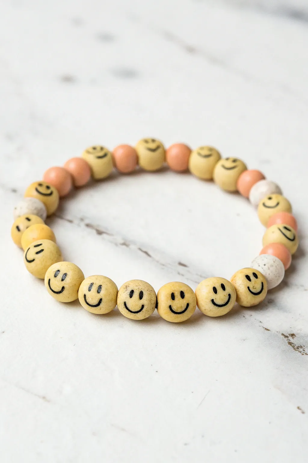 Repeat smiley clay beads for a cheerful, minimalist bracelet that looks handmade and modern.