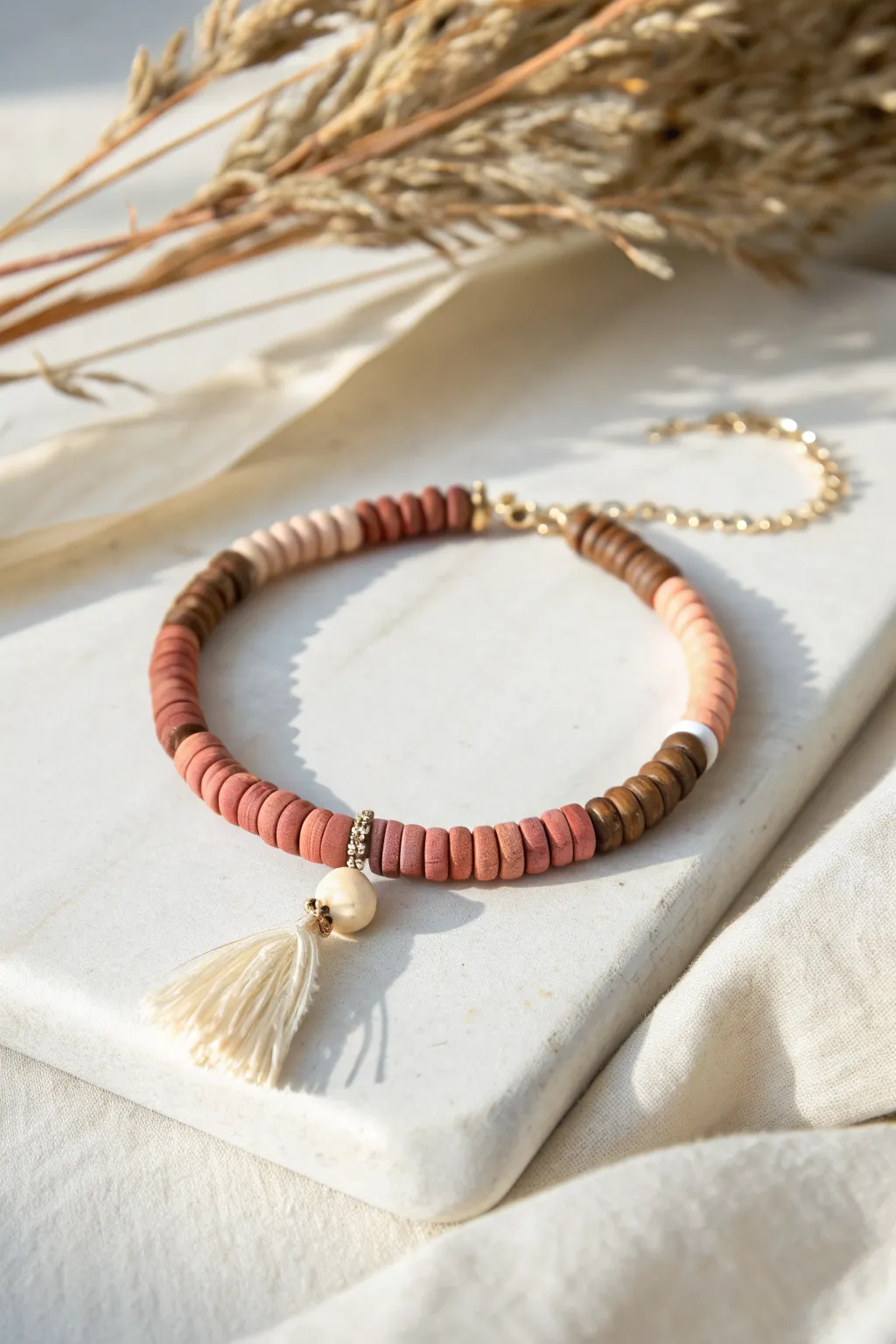 Ombre heishi clay bead bracelet with tassel charm, minimalist Scandinavian-boho vibe