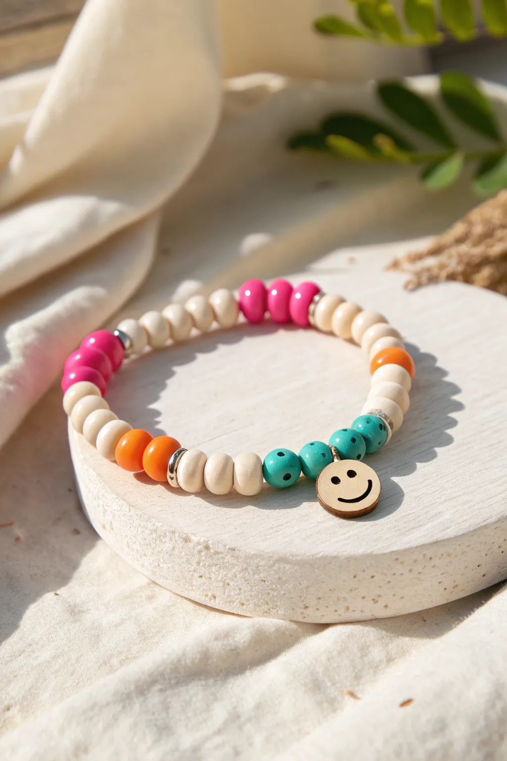 Preppy brights meet a smiley focal bead, stacked simply for a fun, polished look.