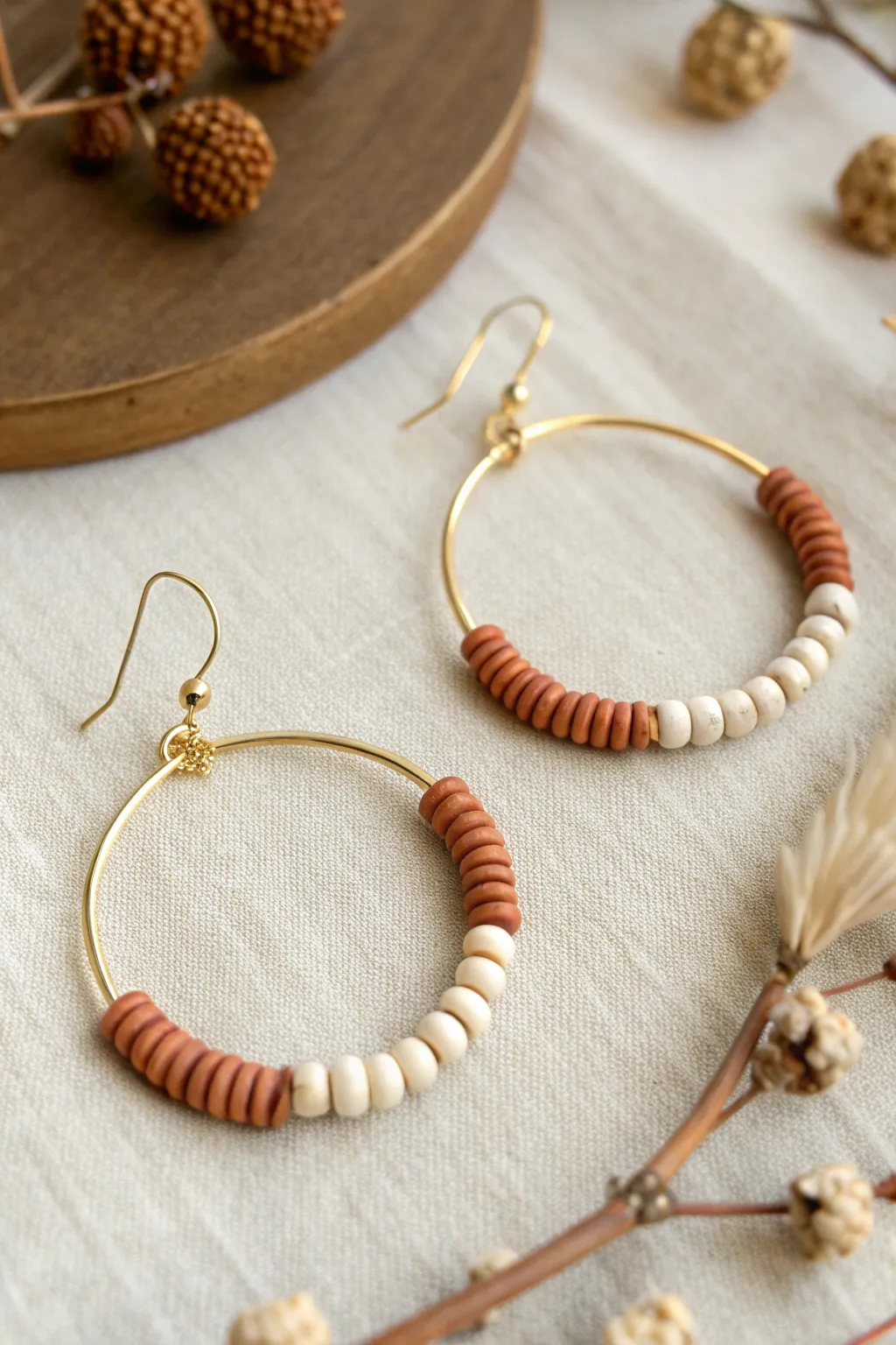 Checkerboard rhythm hoop earring: alternating heishi stacks in calm, modern clay colors
