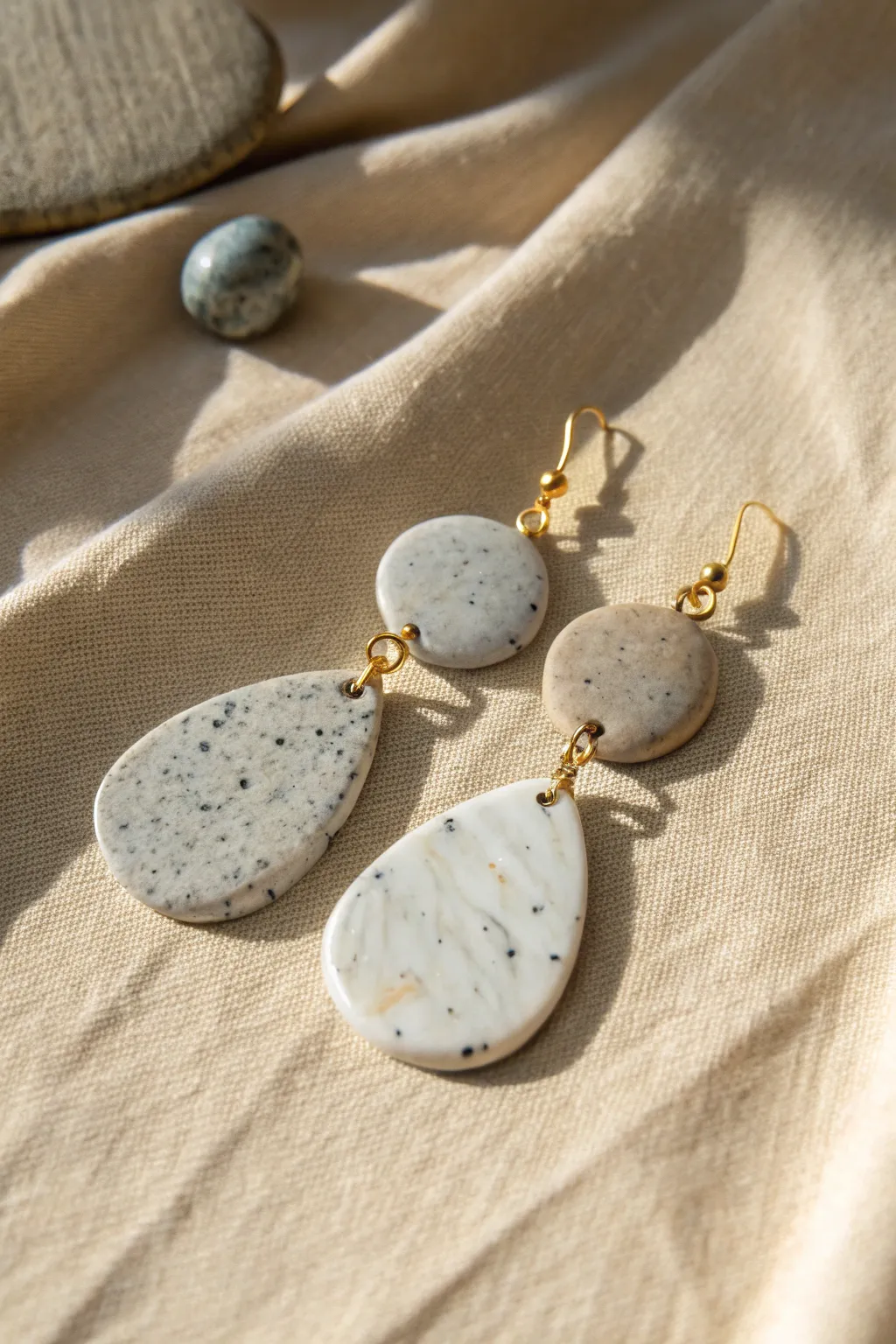 Granite speckles and quartz veining in simple oval clay earrings for a chic faux-stone look