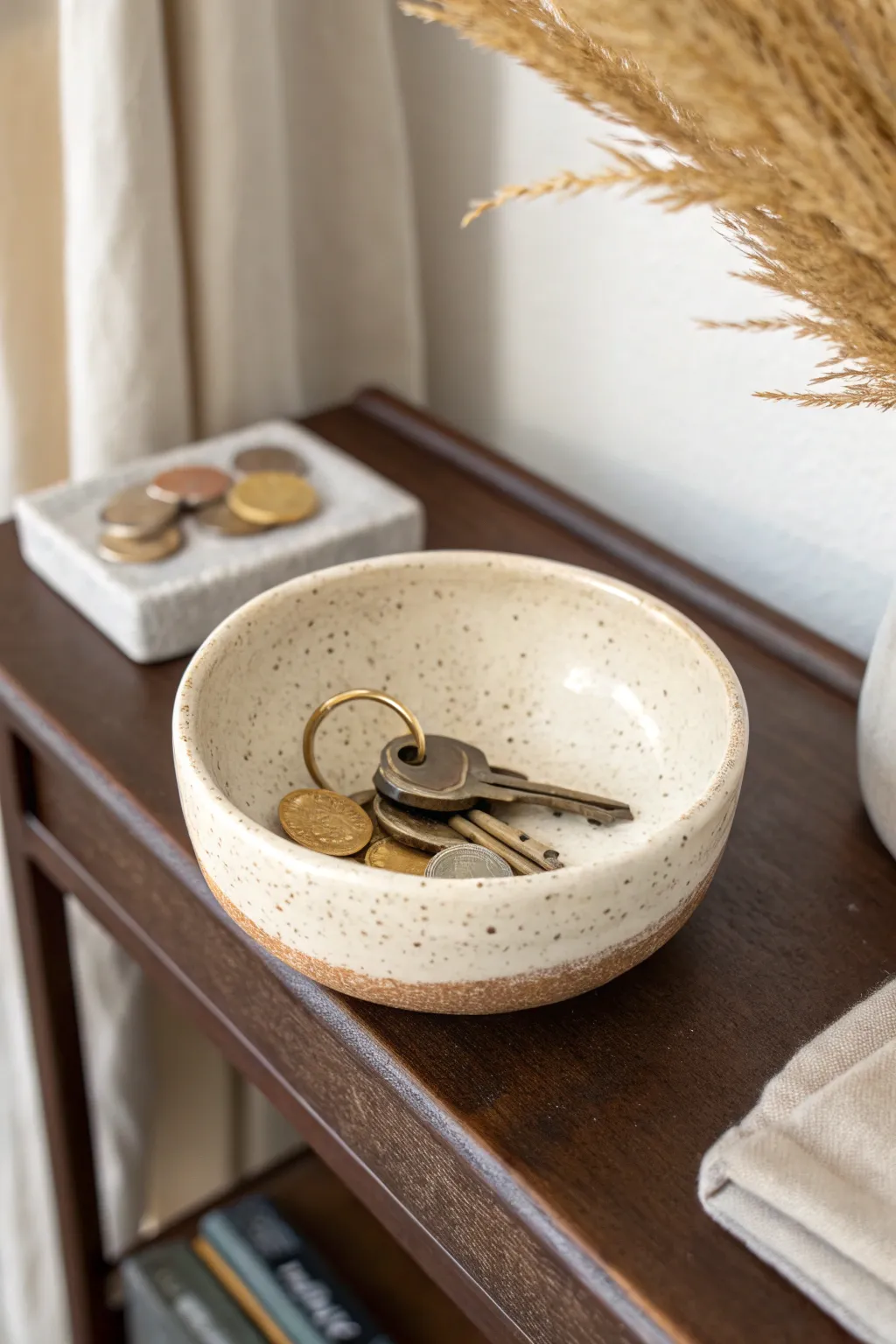 Minimal ceramic key bowl with raised rim, keeping entryway keys and coins calm and chic.