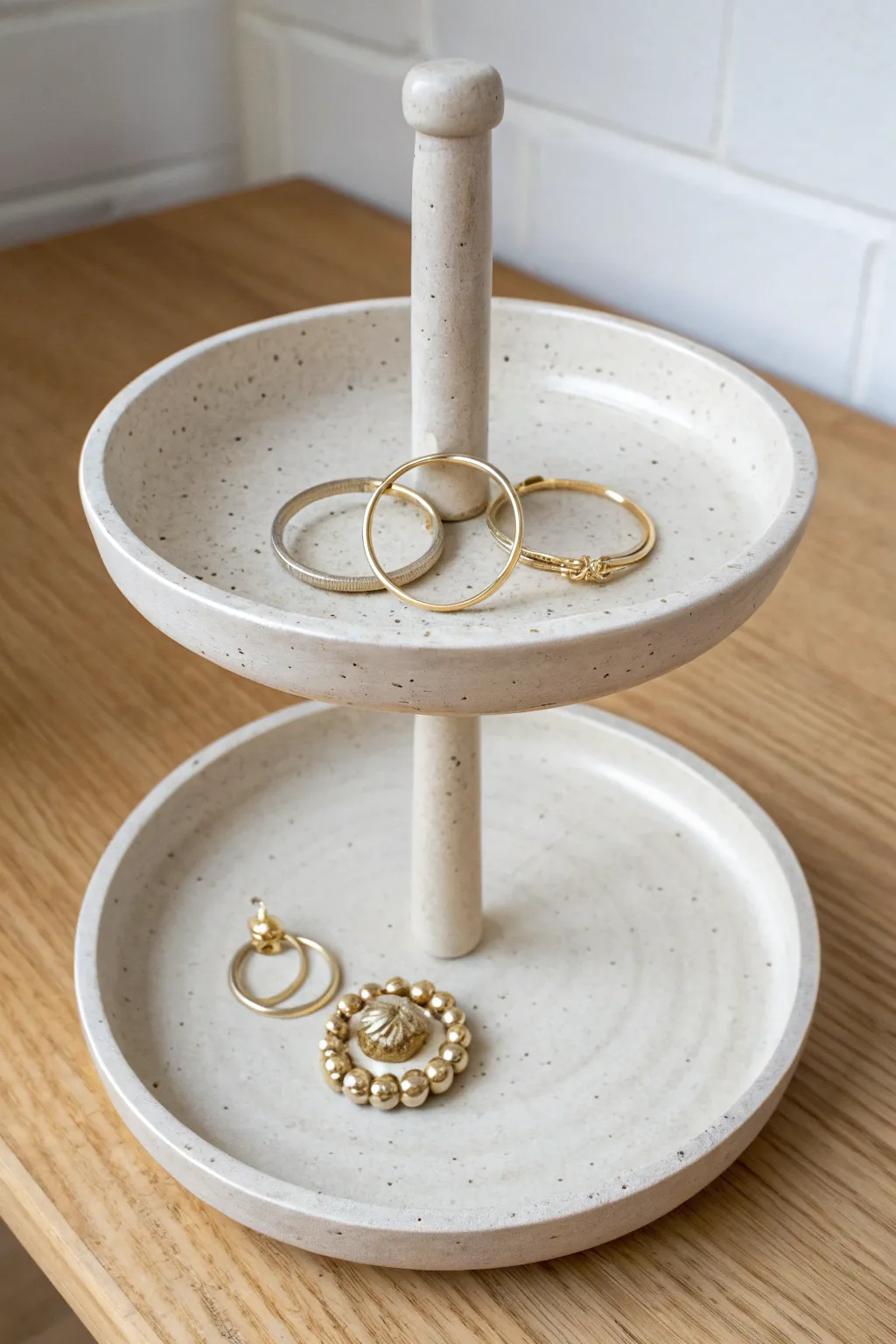 Two-tier clay jewelry stand with clean lines and soft satin finish for rings and bracelets.
