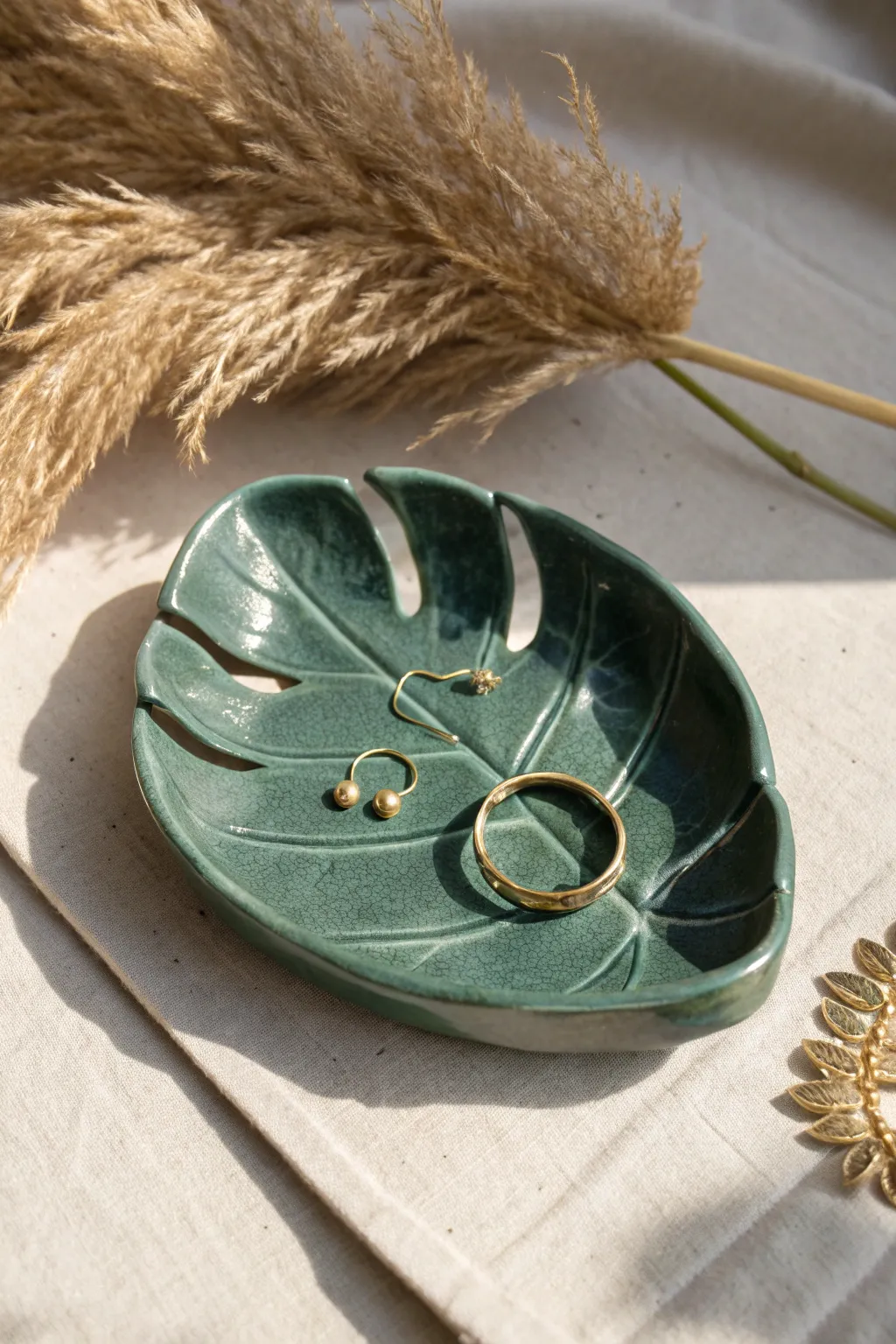 Monstera leaf clay tray in deep green, a chic spot to keep hoops and rings together.