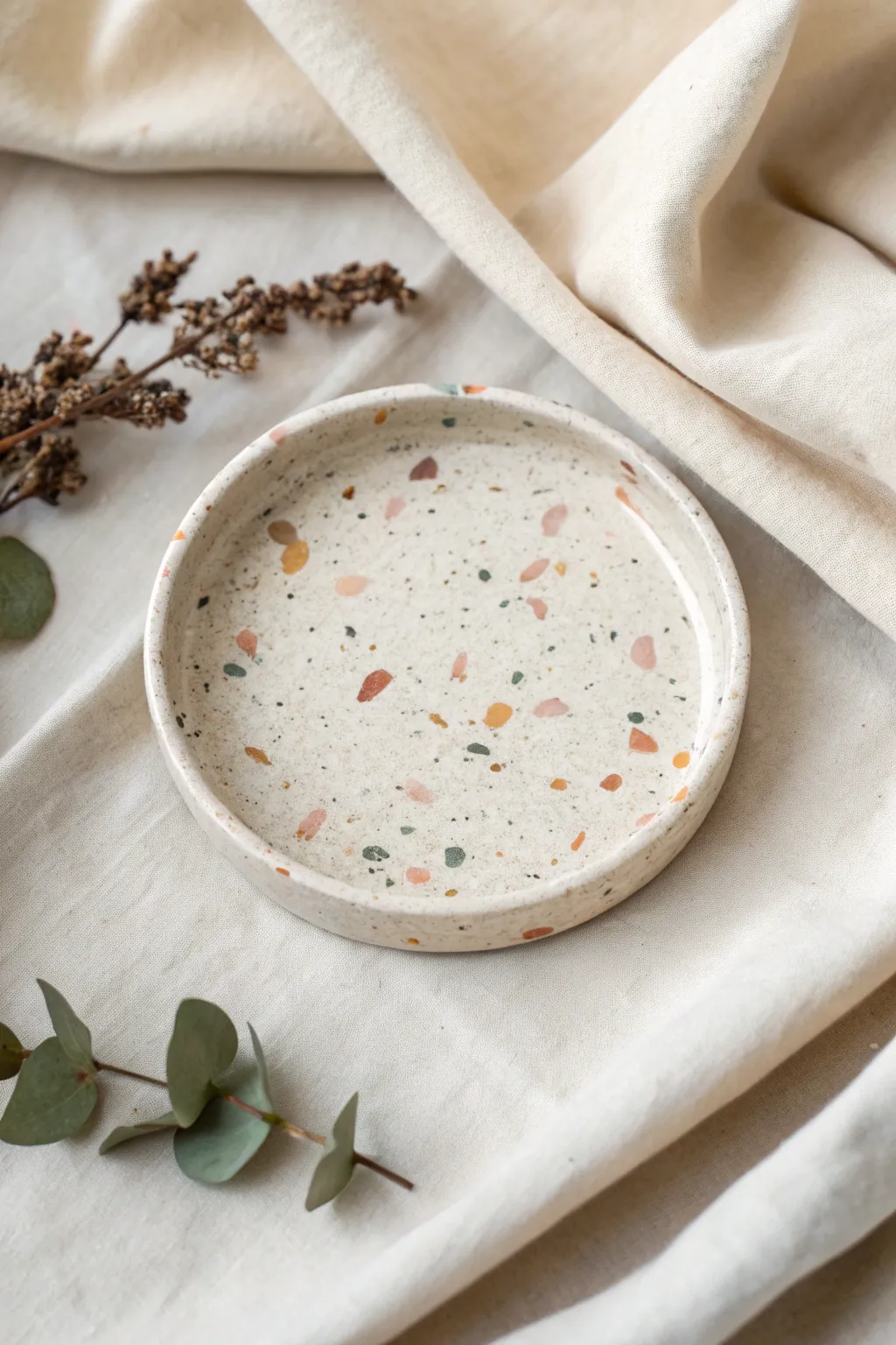 Minimal terrazzo speckle trinket dish on linen, a modern Scandinavian boho clay photo idea