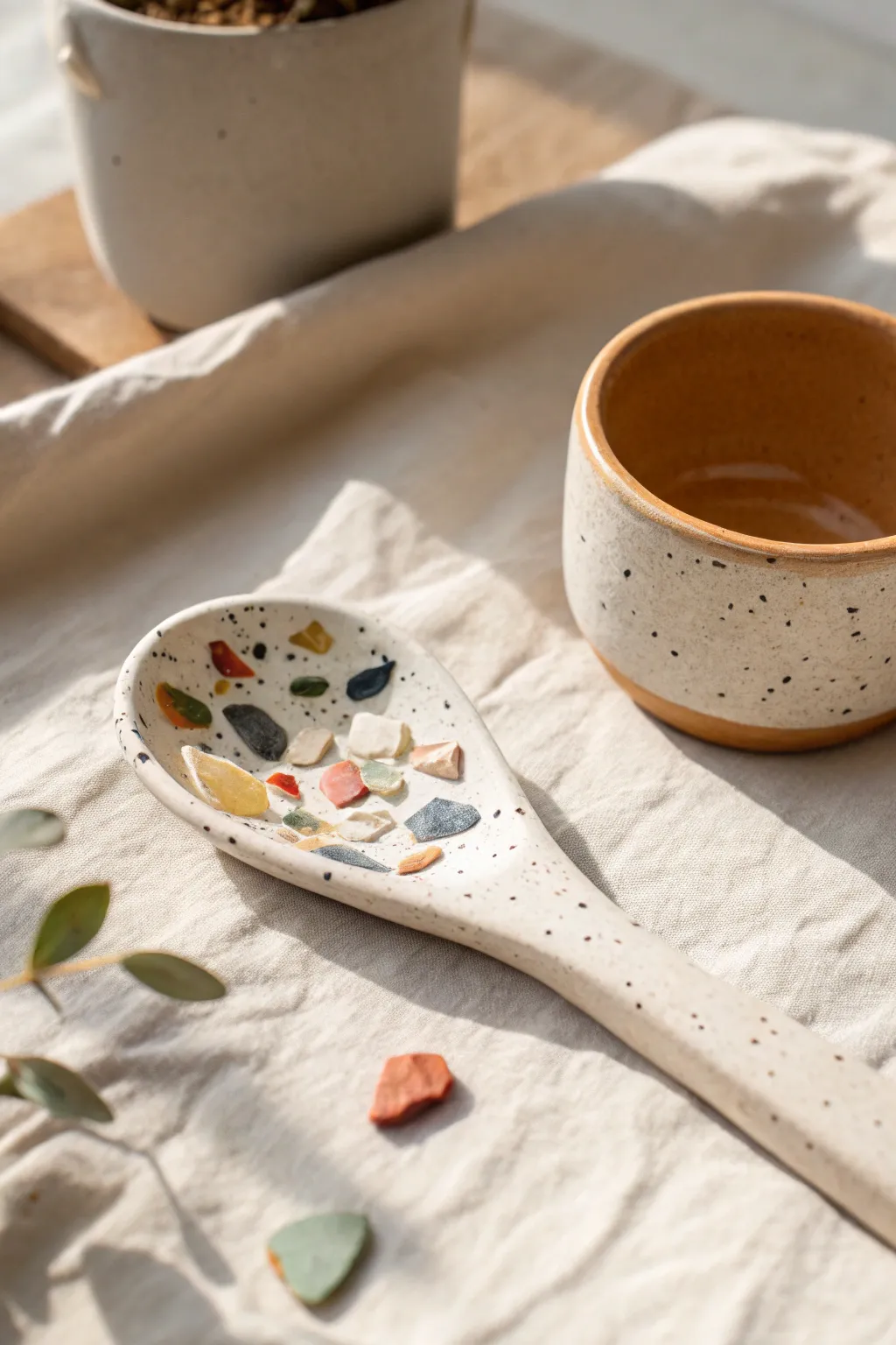 Terrazzo chip clay spoon with soft speckles, styled simply for a modern boho kitchen.
