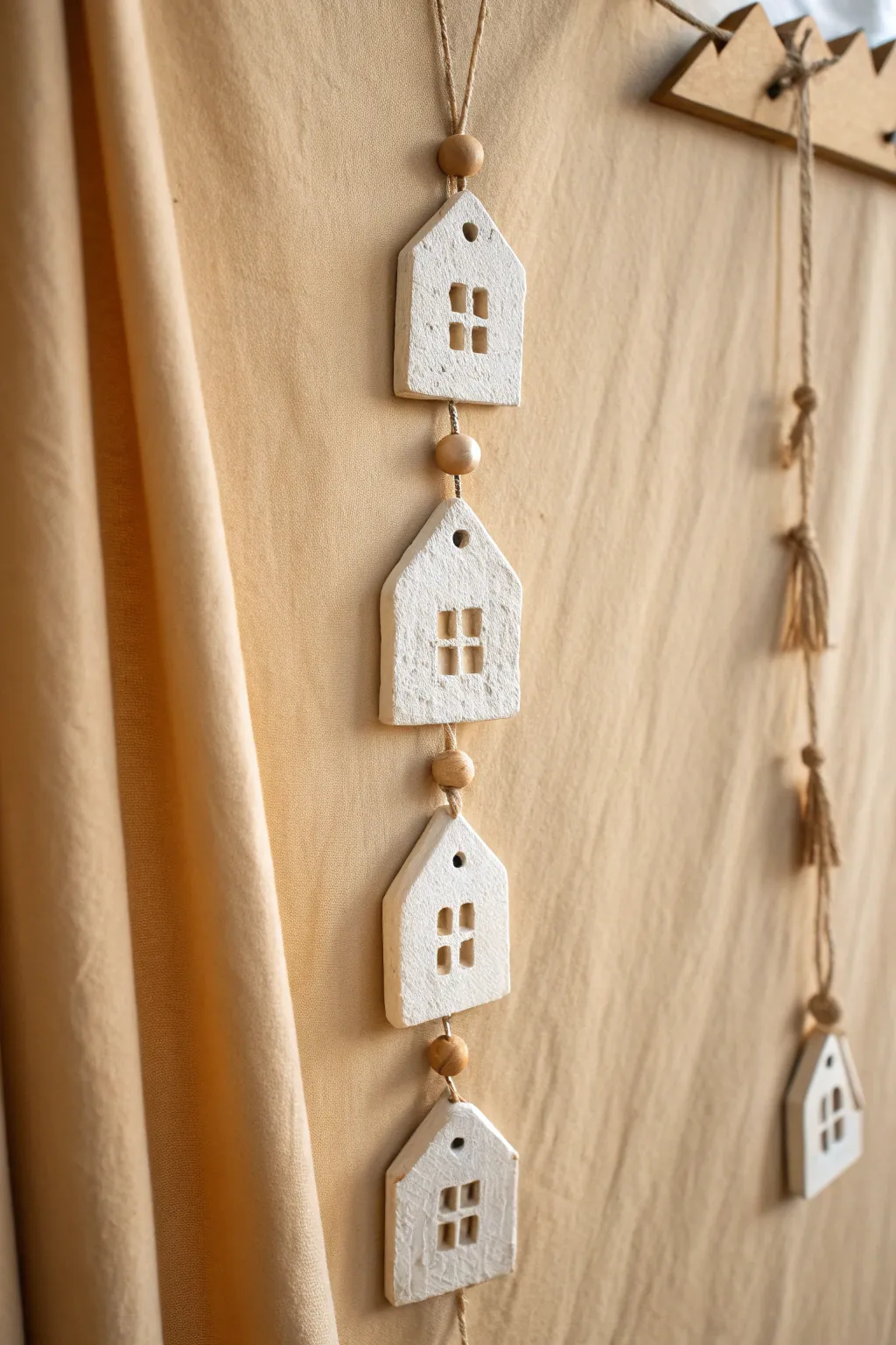 Minimal clay house village wall hanging with matte finish, twine links, and soft boho warmth