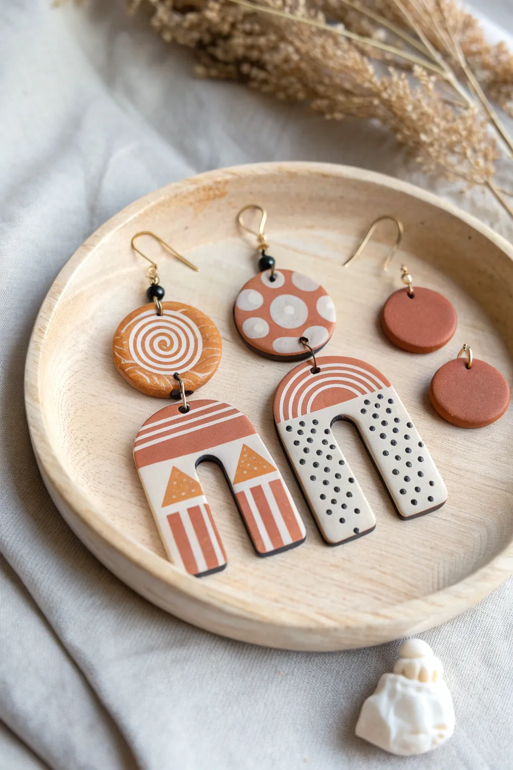 Bold matte polymer clay earrings in modern geometric shapes, minimal patterns, cozy boho tones.