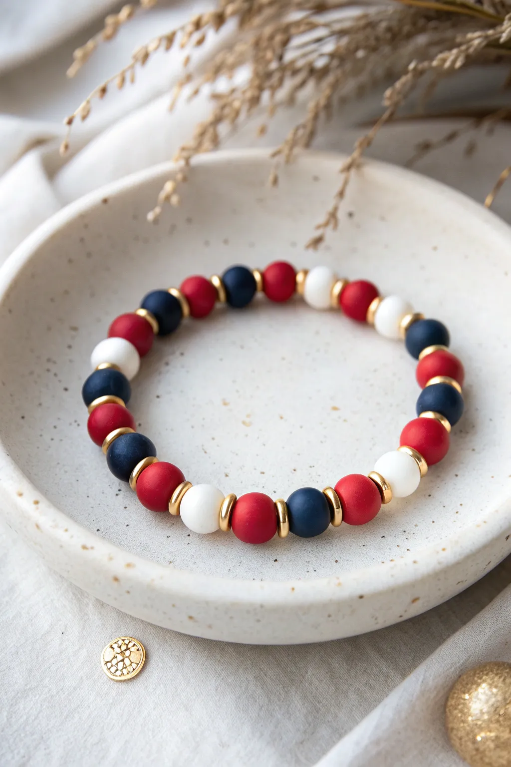 Nutcracker stripe clay bead bracelet in red, navy, white and gold for a chic holiday set