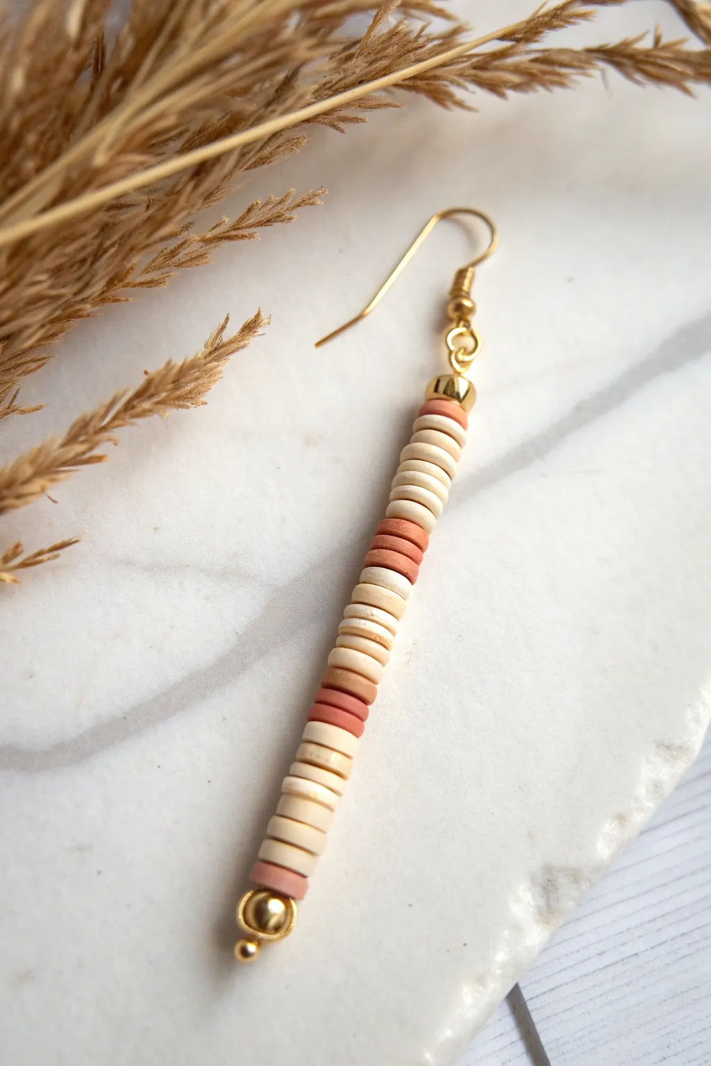 Vertical heishi stack drop earring in soft neutrals, minimalist with a boho sway.